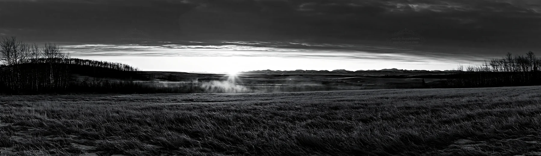 Frosty meadow at sunrise with mist and hills in the distance - AI-generated stock image