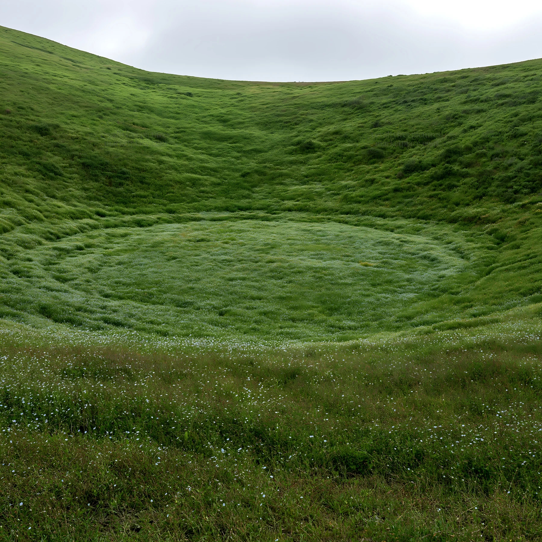 Cloudy foothill meadow with circular green area - AI-generated stock image