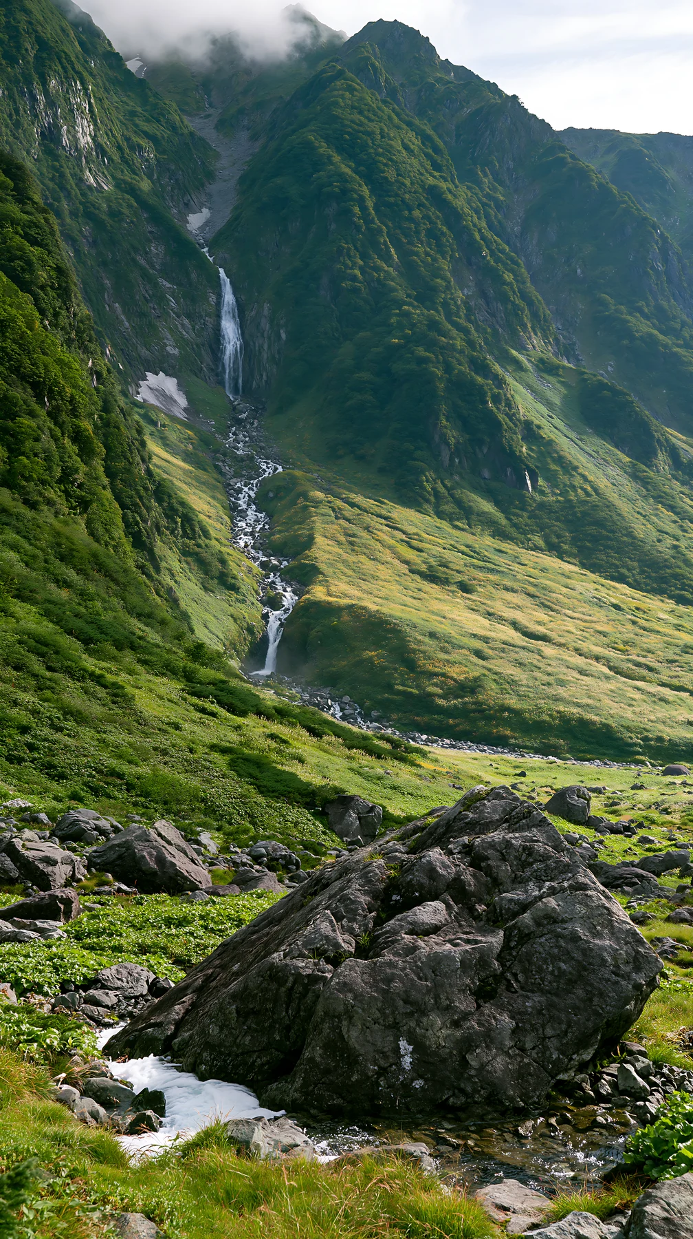 Toyama alpine meadow snowmelt rock foreground showcases natural beauty - AI-generated stock image