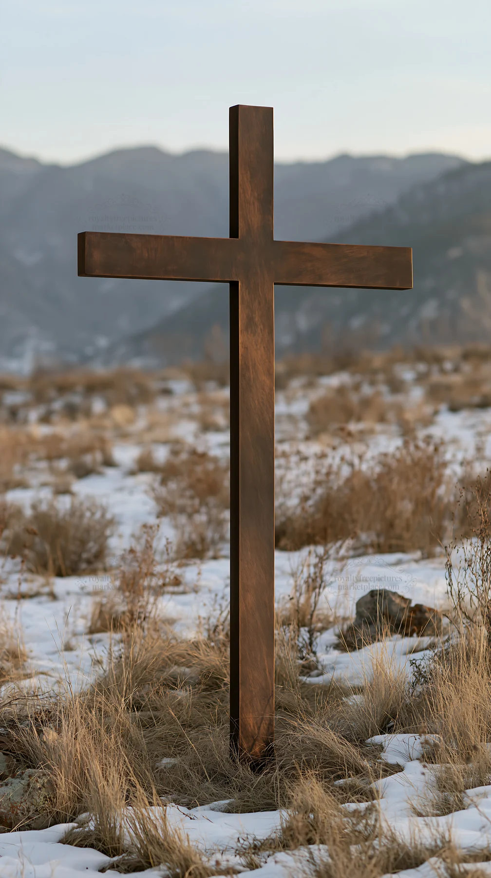 Bronze Christian cross in a snowy meadow during Christmas season - AI-generated stock image