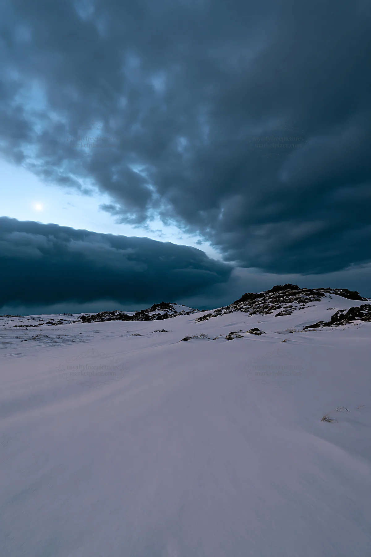 Snowbound meadow under cloudy sky in winter - AI-generated stock image
