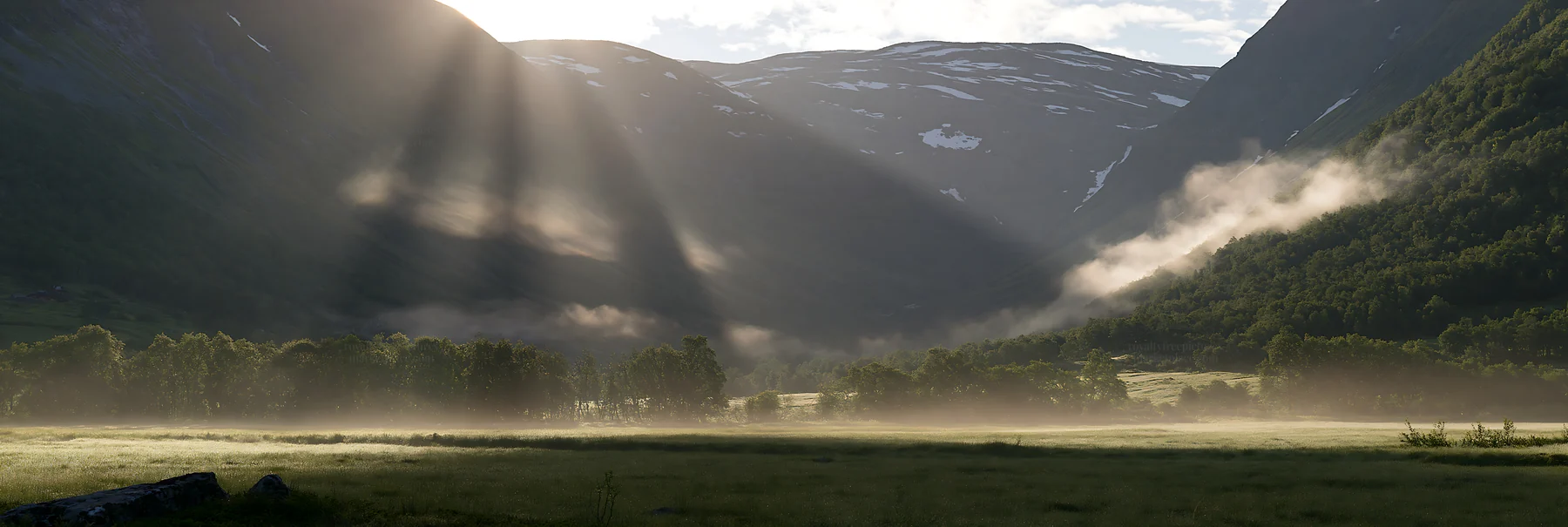 Meadow mountain sunrays illuminate a valley in morning light - AI-generated stock image