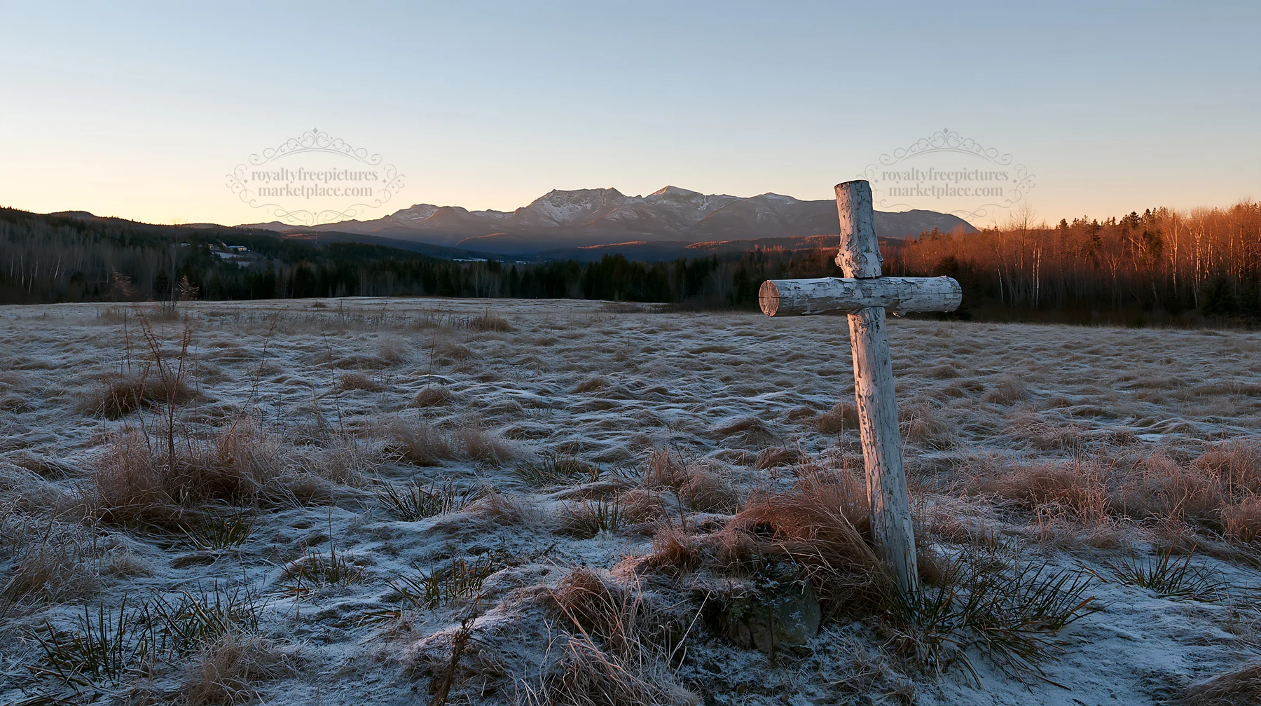 Whitewashed Christian cross in a winter meadow at sunset - AI-generated stock image