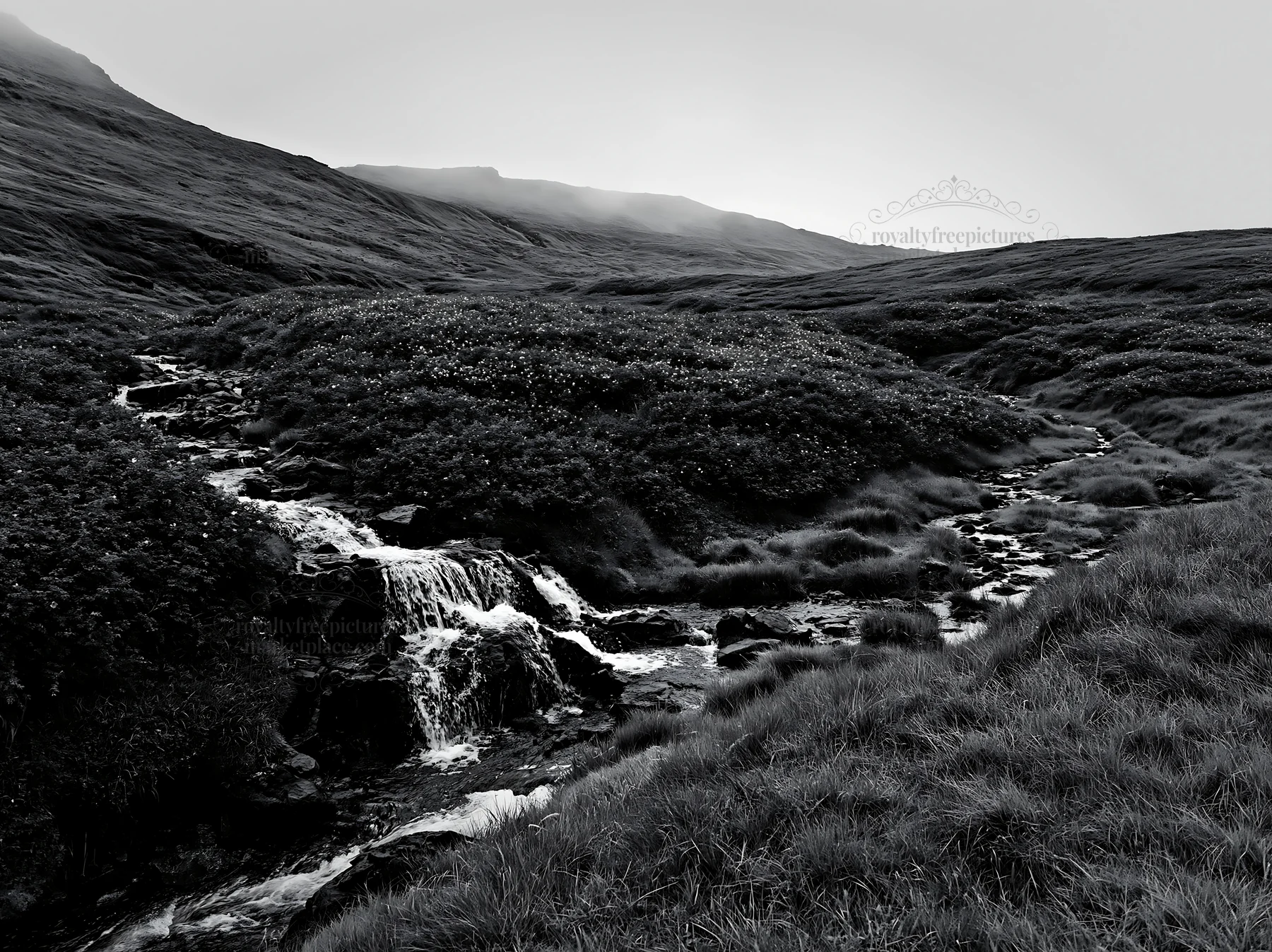 Waterfall flowing through a meadow with hills in the distance - AI-generated stock image
