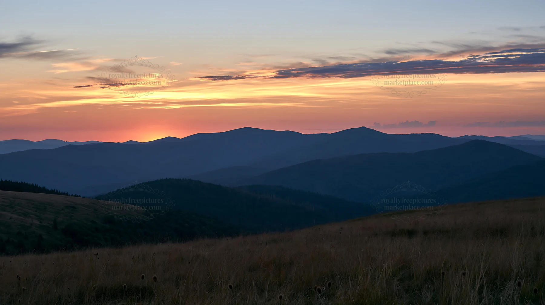 Sunset over mountains and meadow landscape - AI-generated stock image