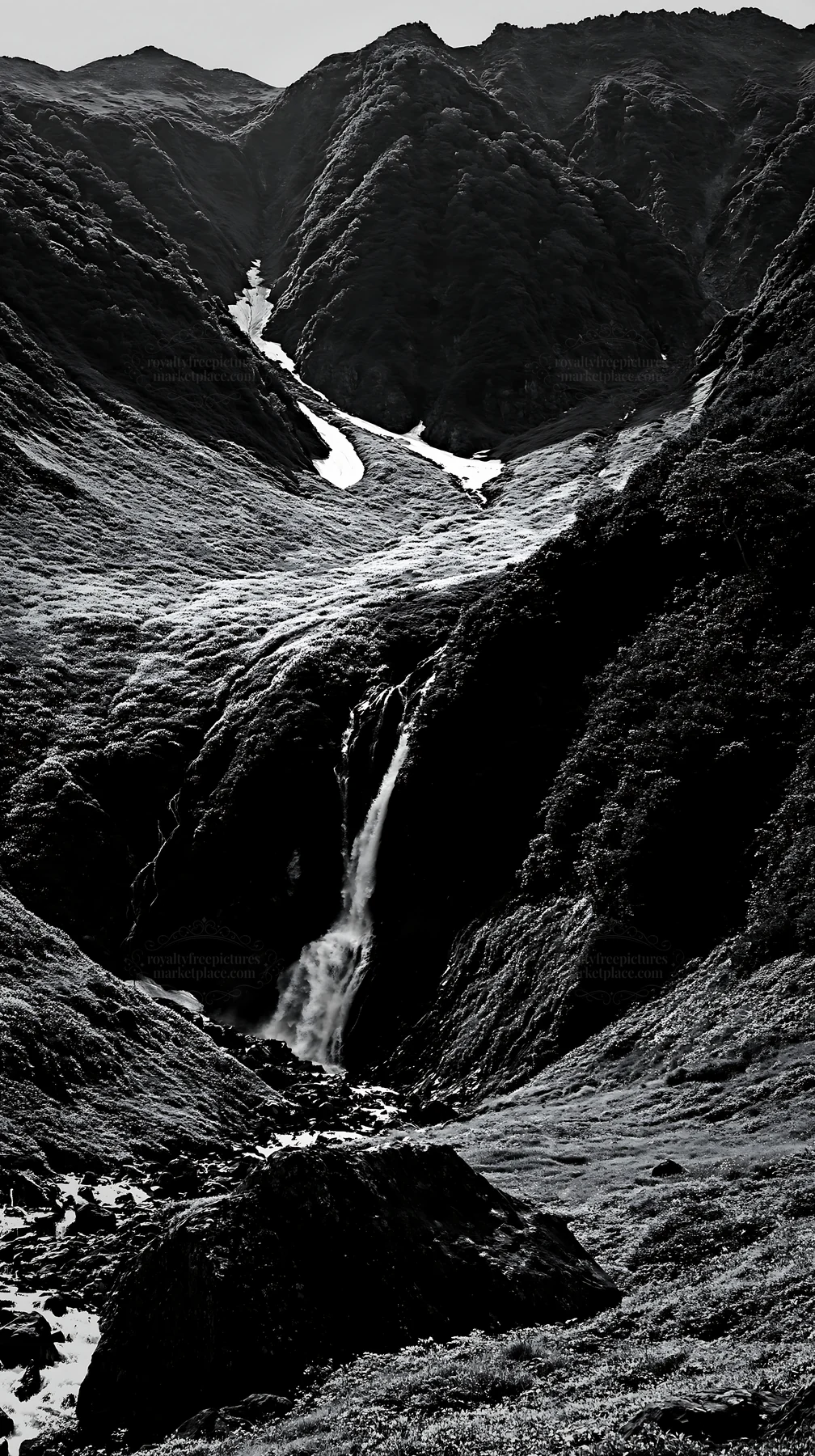 Snowmelt waterfall in Toyama alpine meadow with rocky foreground - AI-generated stock image