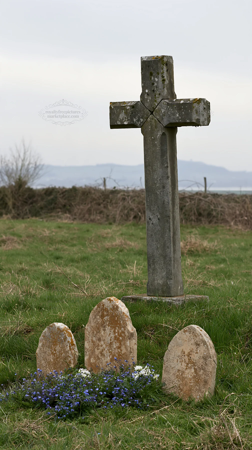 Rustic Christian cross in winter meadow with stones - AI-generated stock image