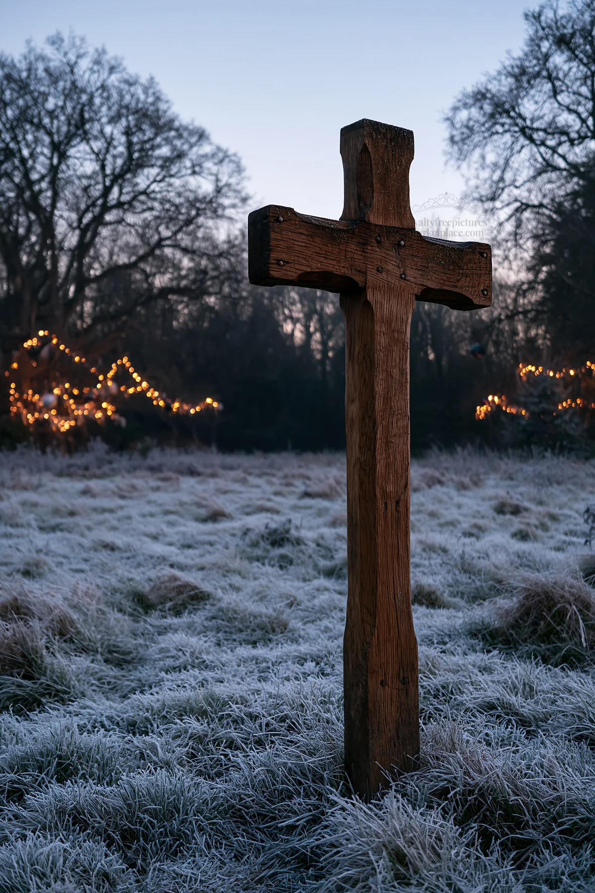 Carved oak cross stands in frosted meadow at dawn - AI-generated stock image