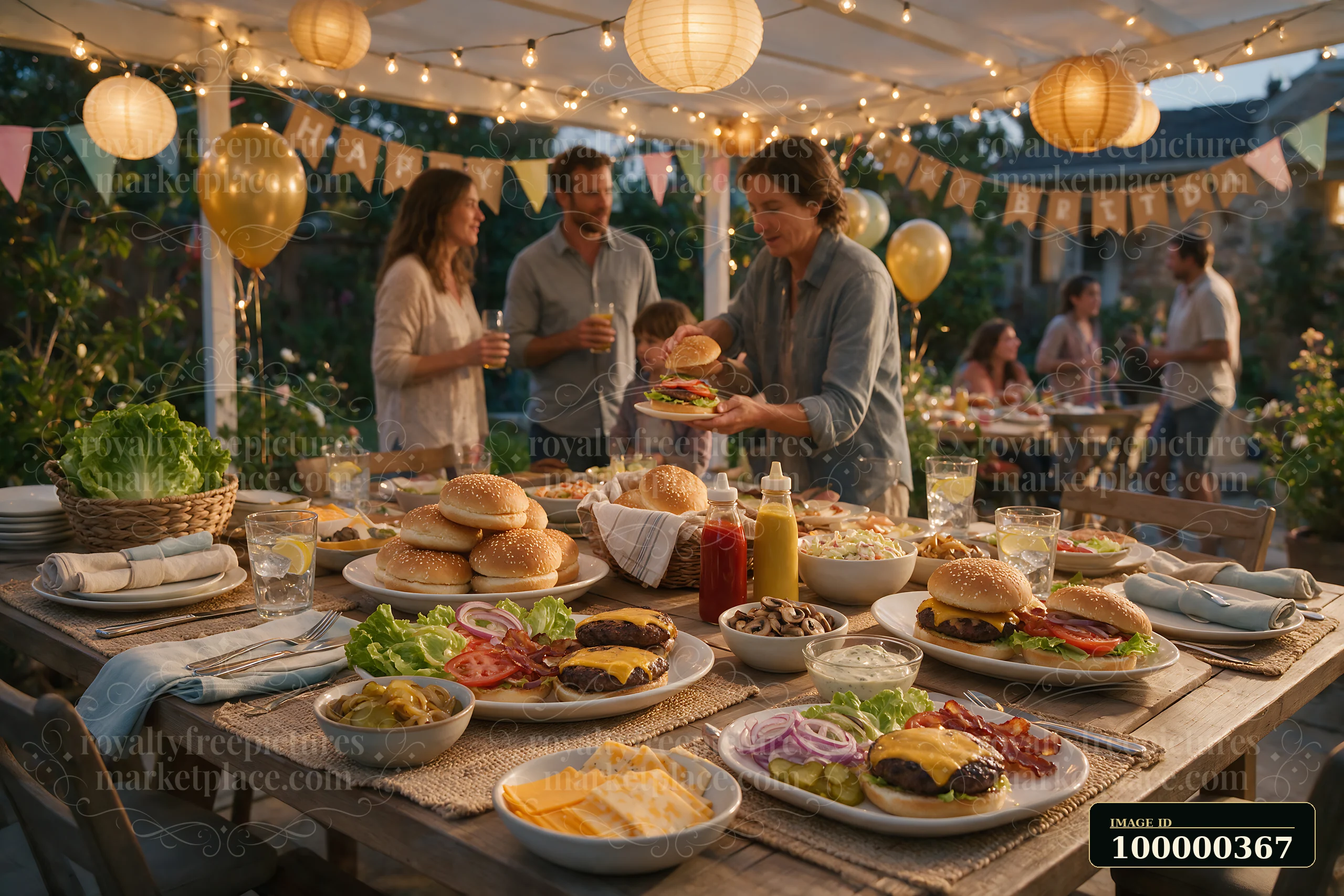 Outdoor burger buffet with toppings and sauces at a festive evening gathering under string lights.