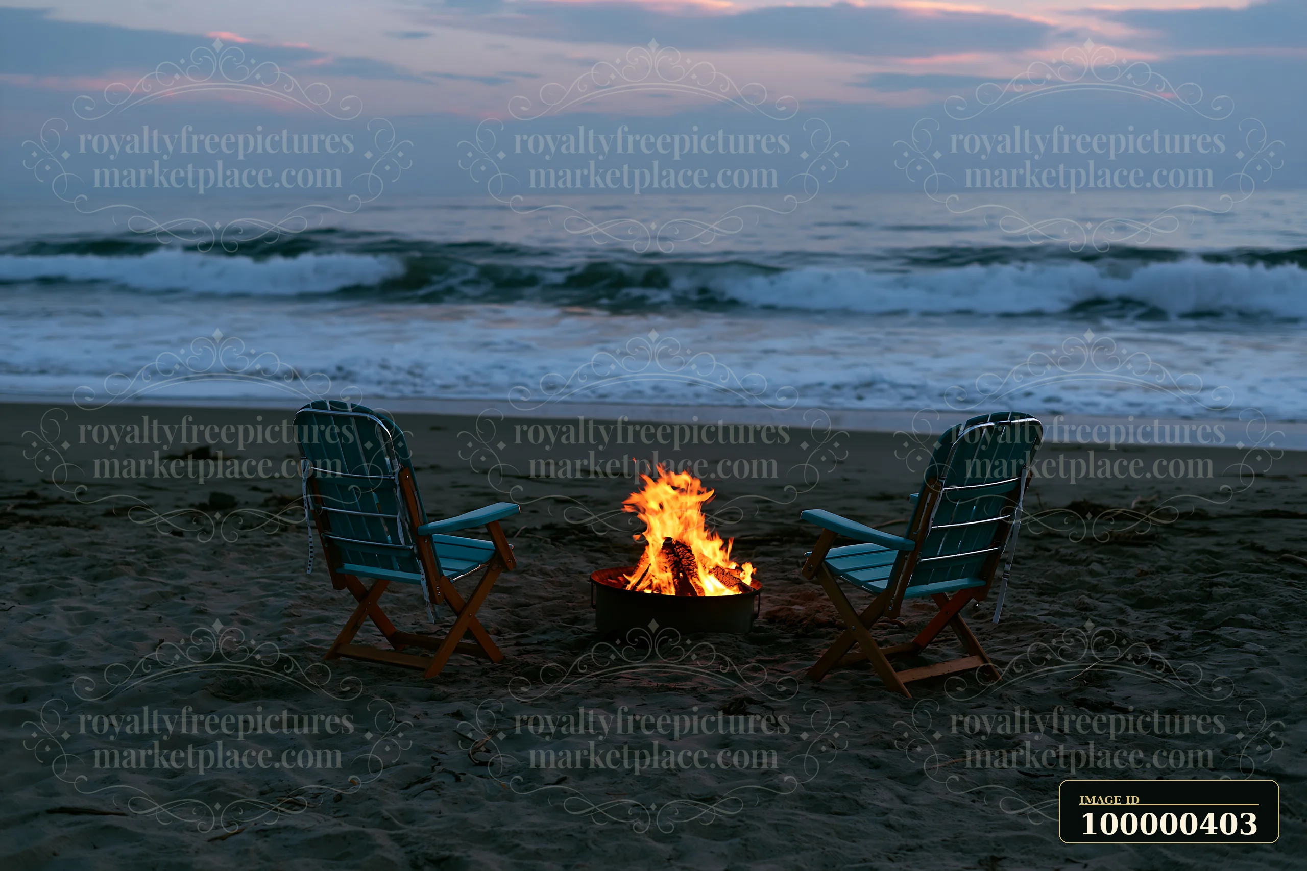 The scene shows two chairs facing a bonfire on the sand at a coastline during sunset.