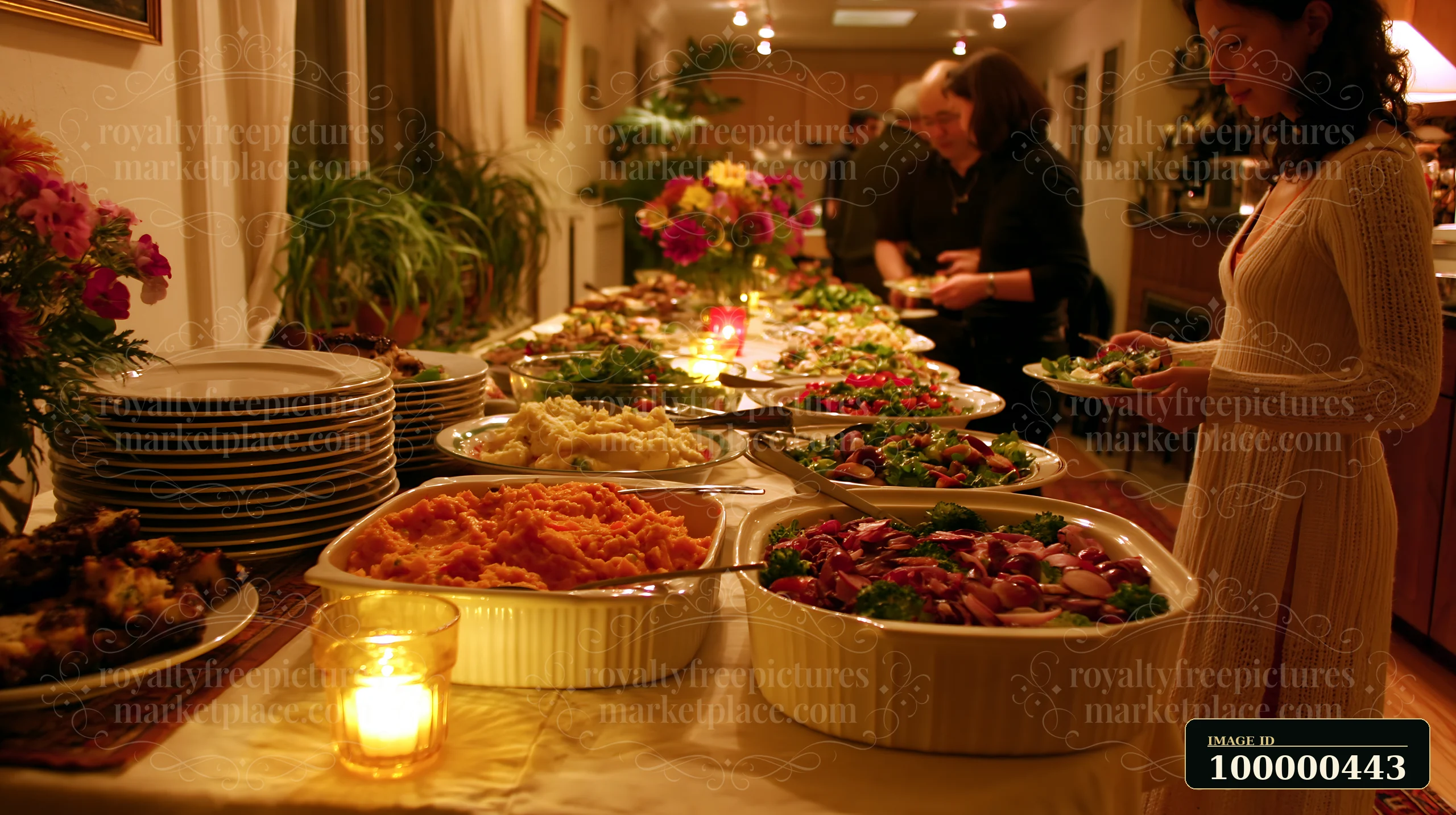 A woman serves herself from a long table filled with various dishes during a gathering.