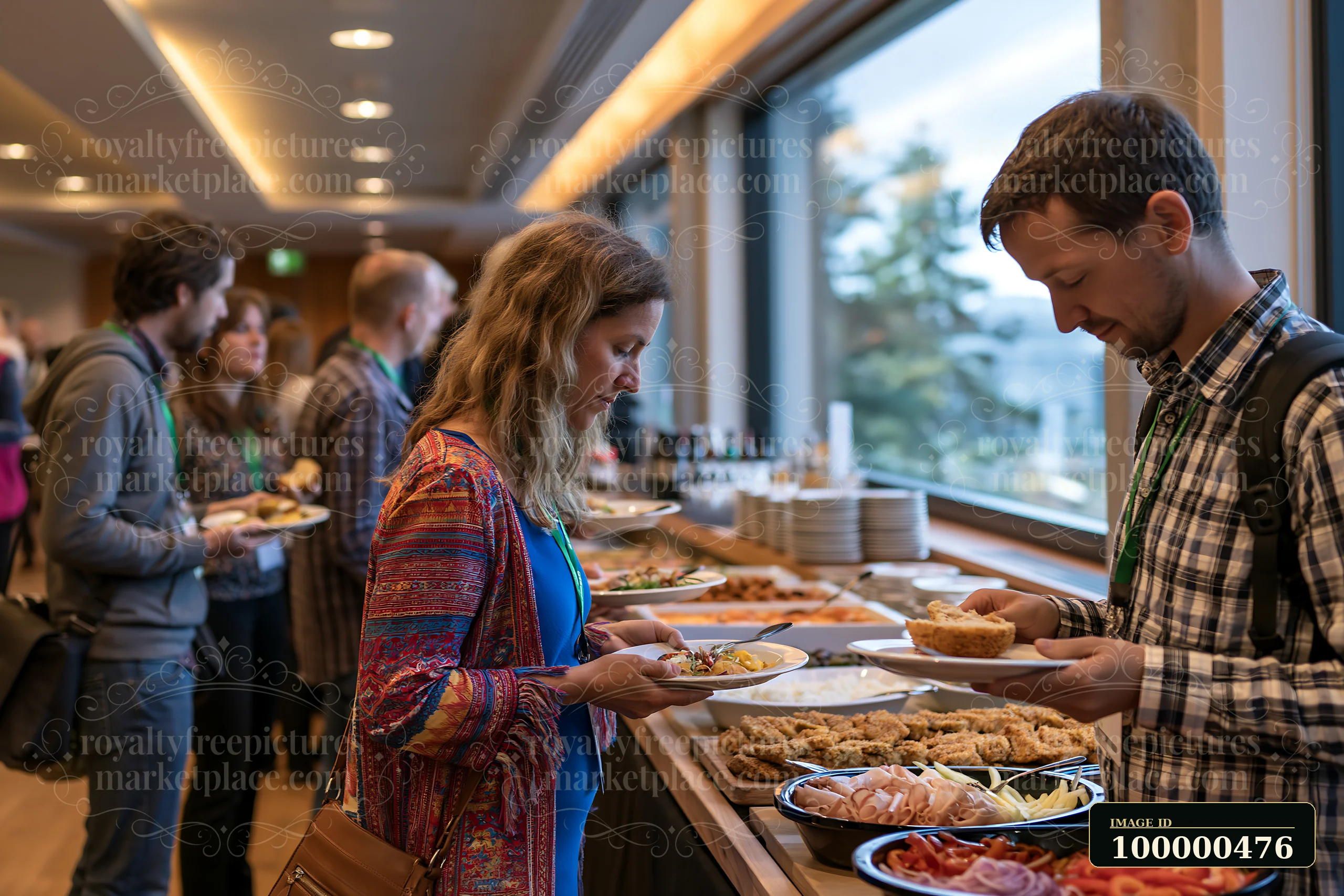 A group of people are serving themselves food from a buffet table during a social event.