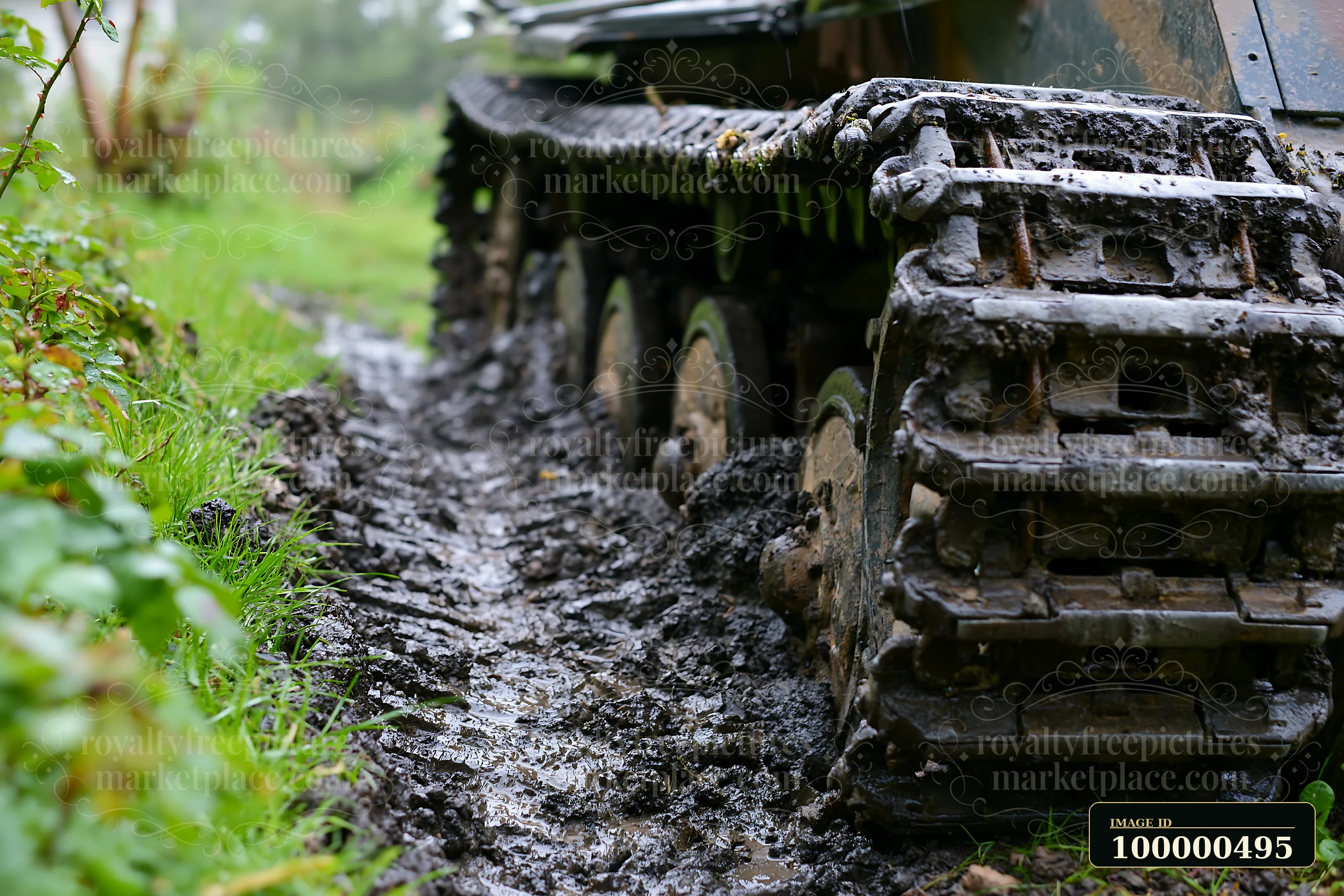 Panzer tank tracks close-up show the treads gripping a muddy path surrounded by greenery.