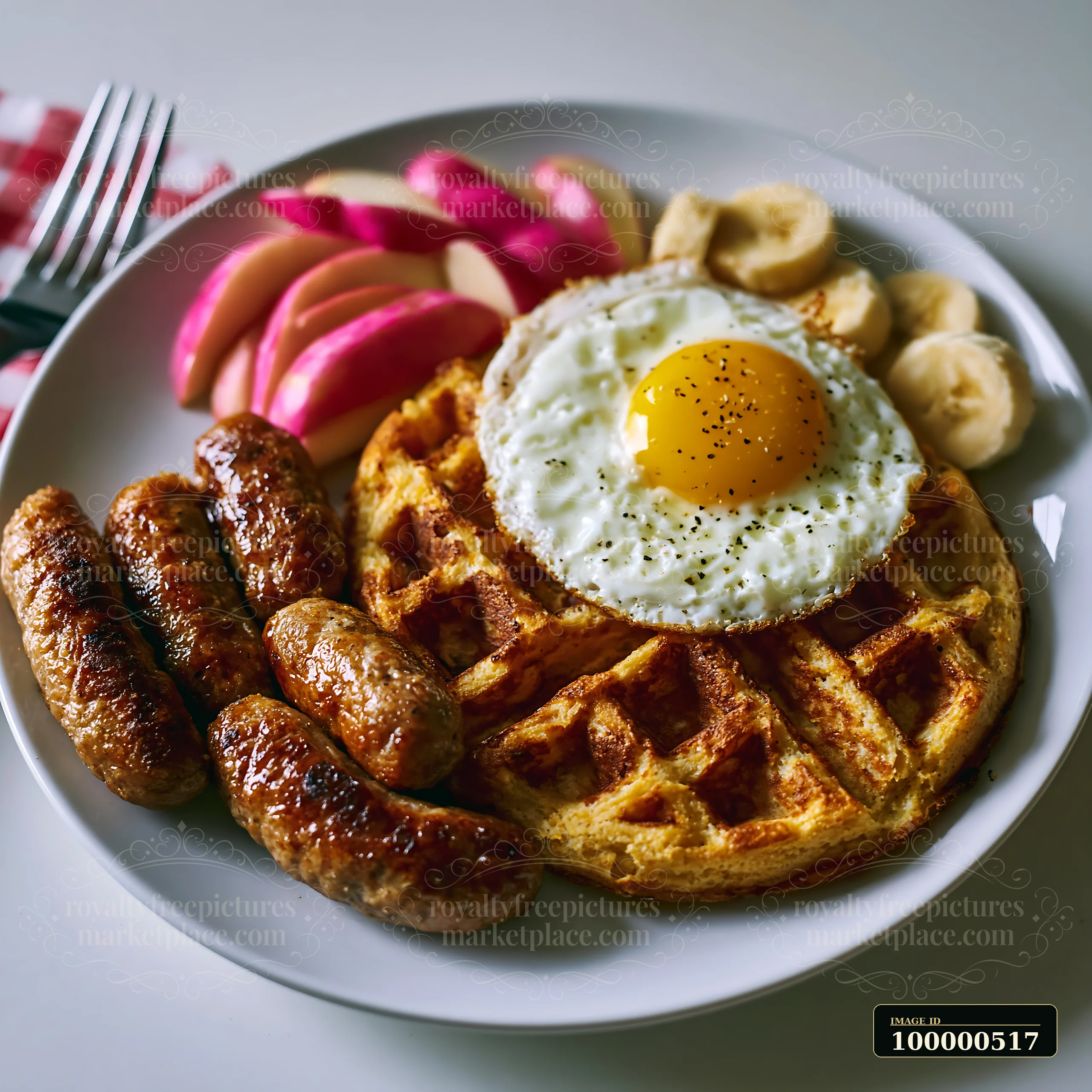 A breakfast plate features a golden waffle topped with a fried egg, alongside sausage links, sliced apples, and banana pieces, creating a filling meal suitable