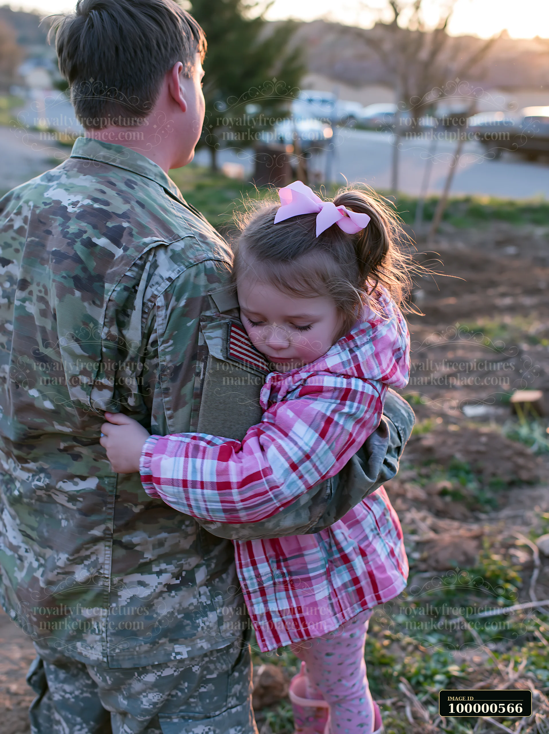 A soldier embraces a young girl in a natural setting, marking a heartfelt reunion.