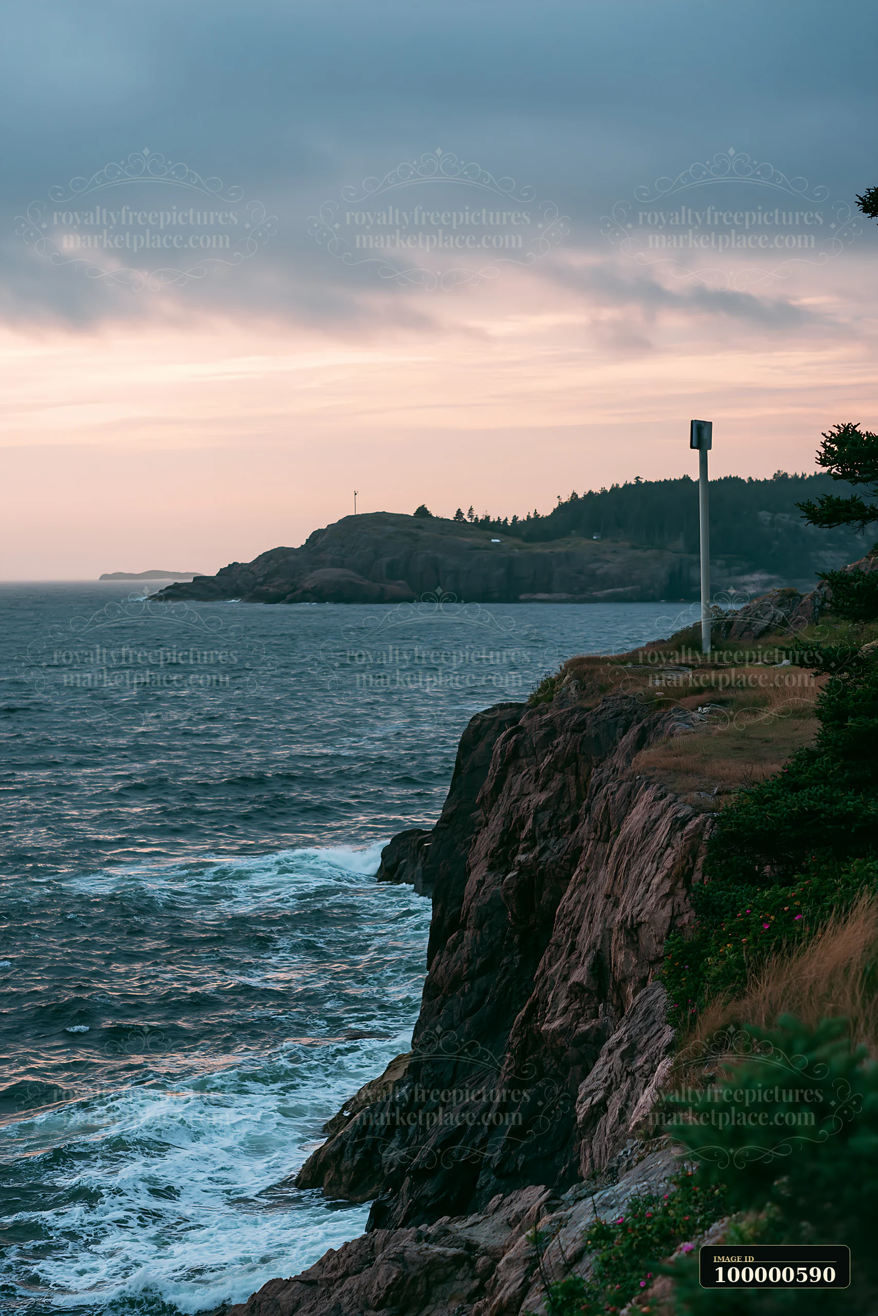 A rocky coastline is visible with waves crashing against the shore.