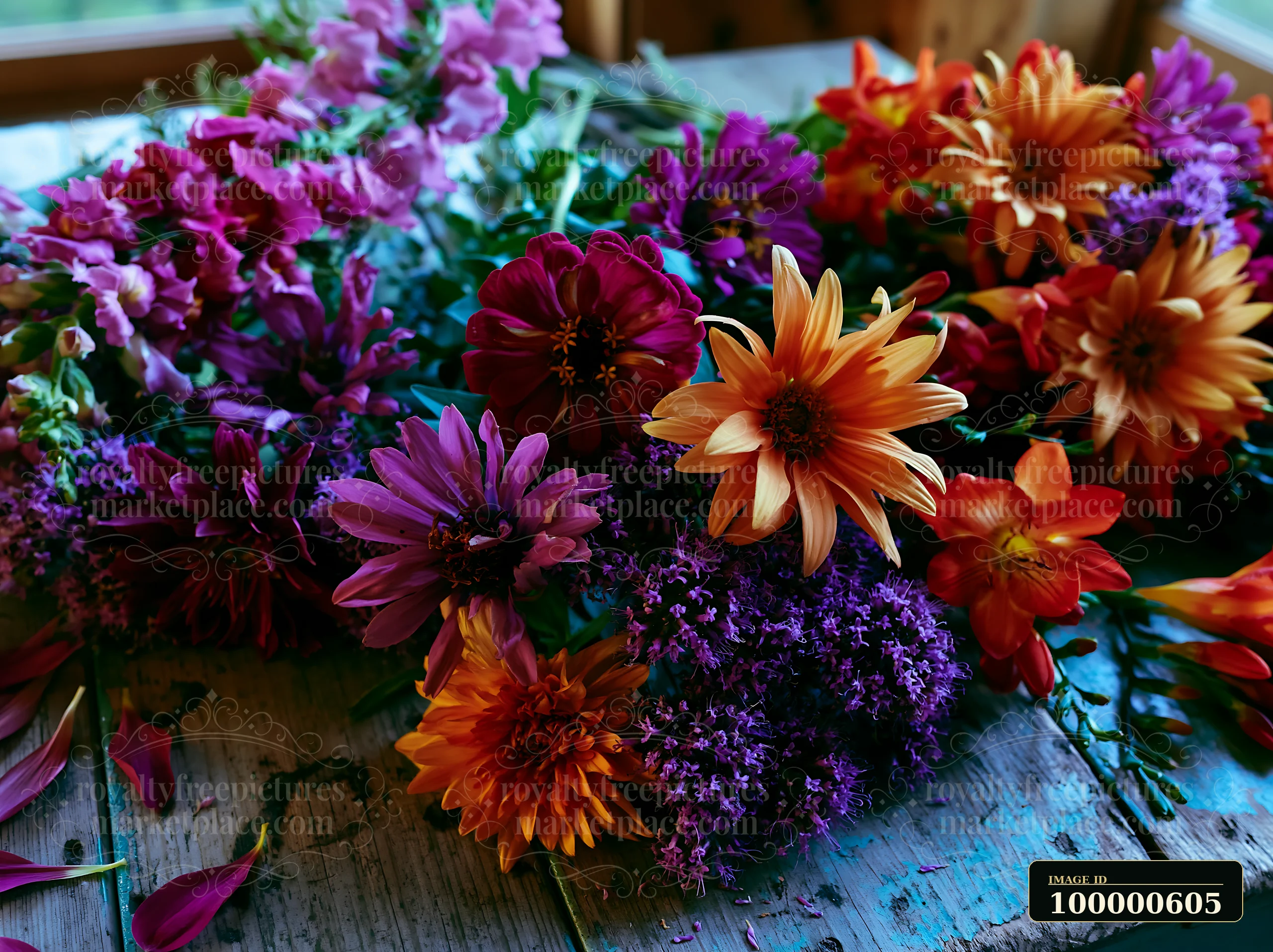 A collection of mixed seasonal flowers is arranged on a wooden table, showcasing vibrant colors and various types, often found at farmers markets.