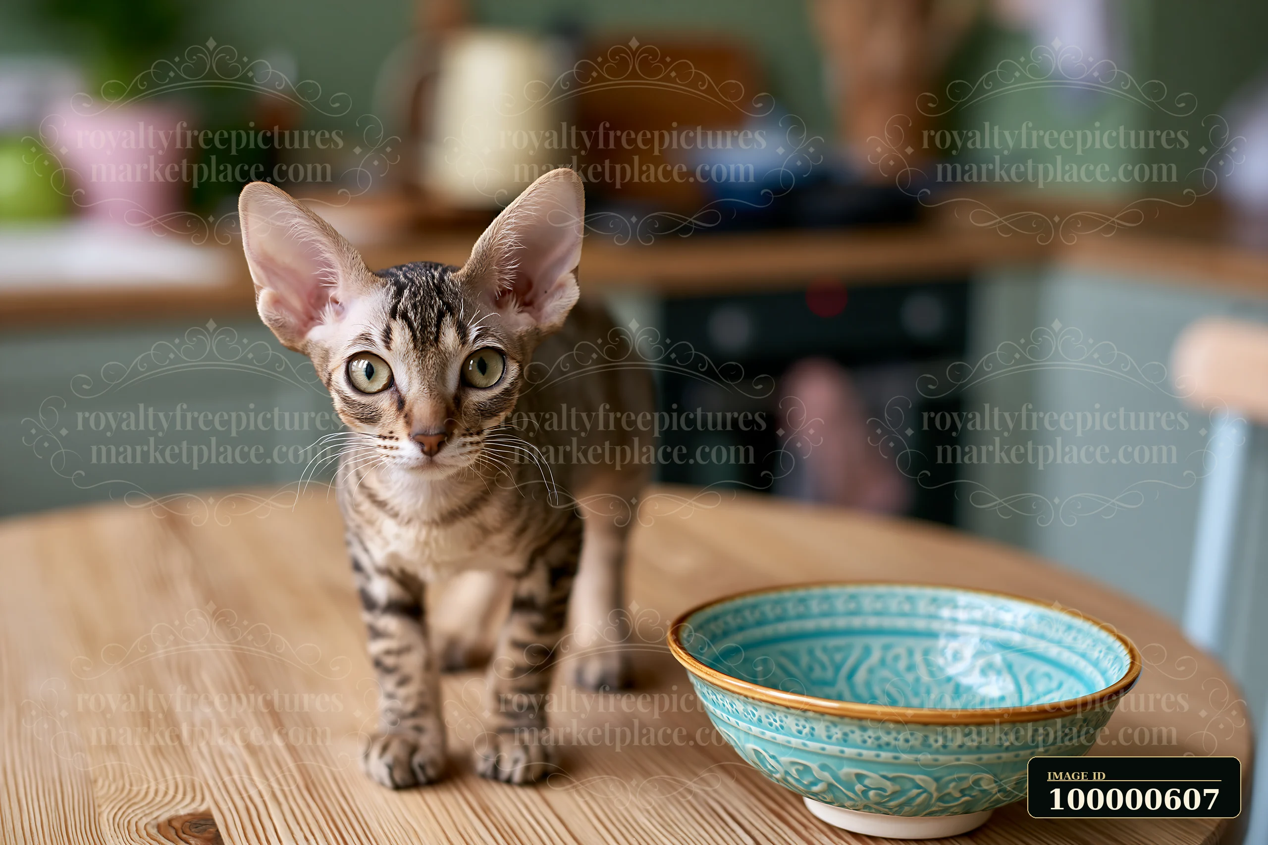 A cat with a distinct pattern walks across a wooden table next to a decorative bowl.