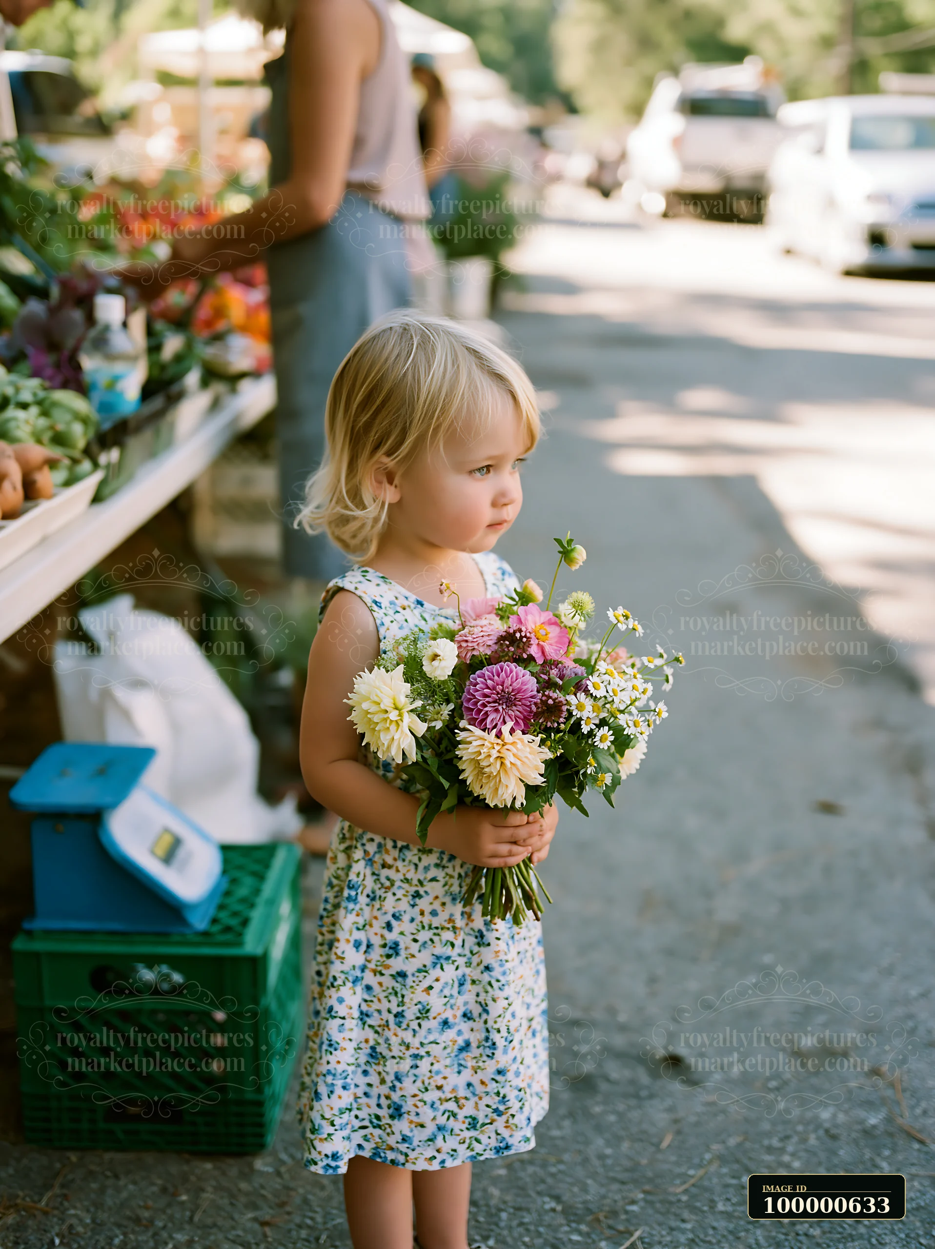 A child stands holding a bouquet of flowers in a vibrant market.