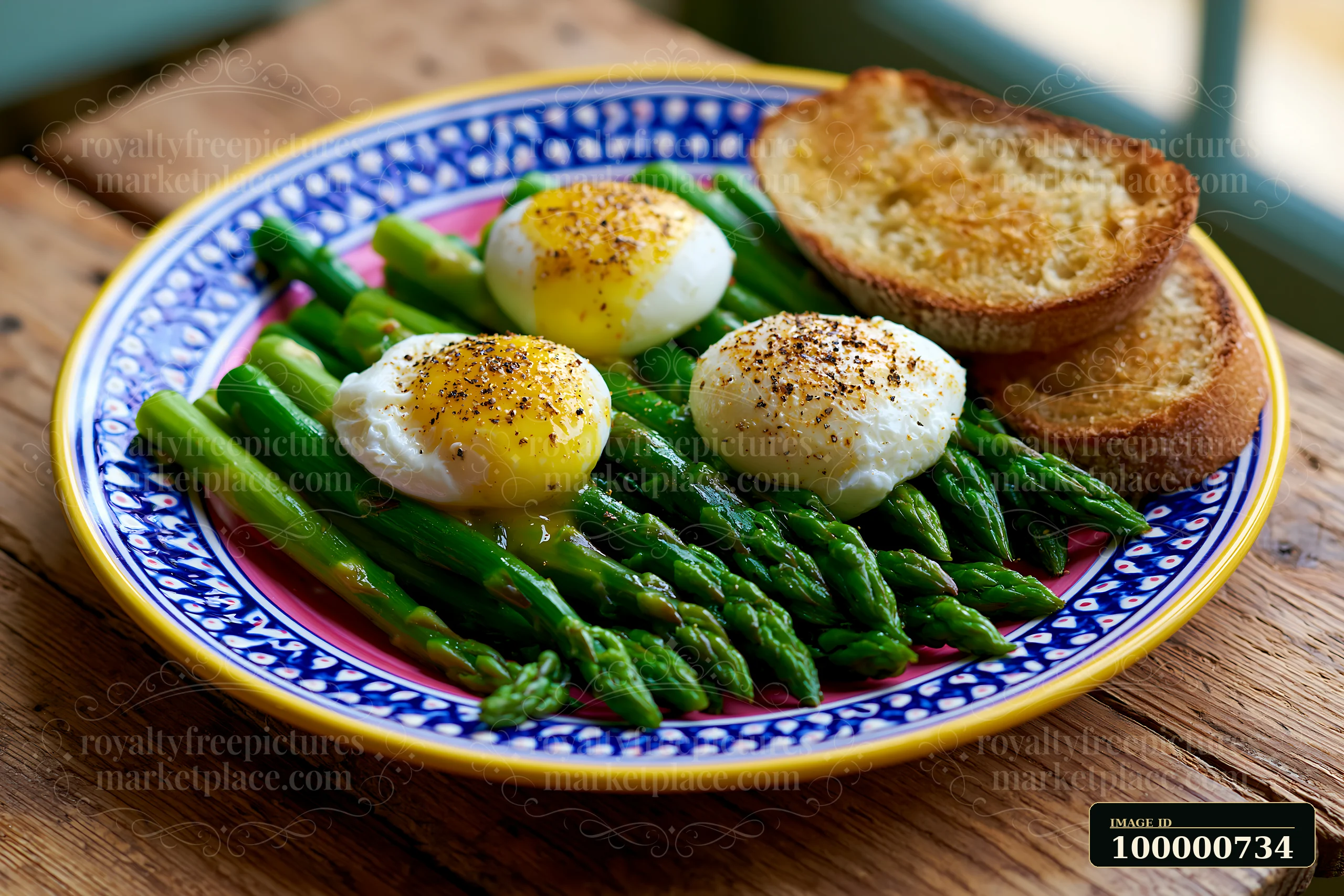 Freshly cooked poached eggs sit atop steamed asparagus with two slices of toasted bread on a blue and yellow patterned plate, perfect for a spring breakfast pla