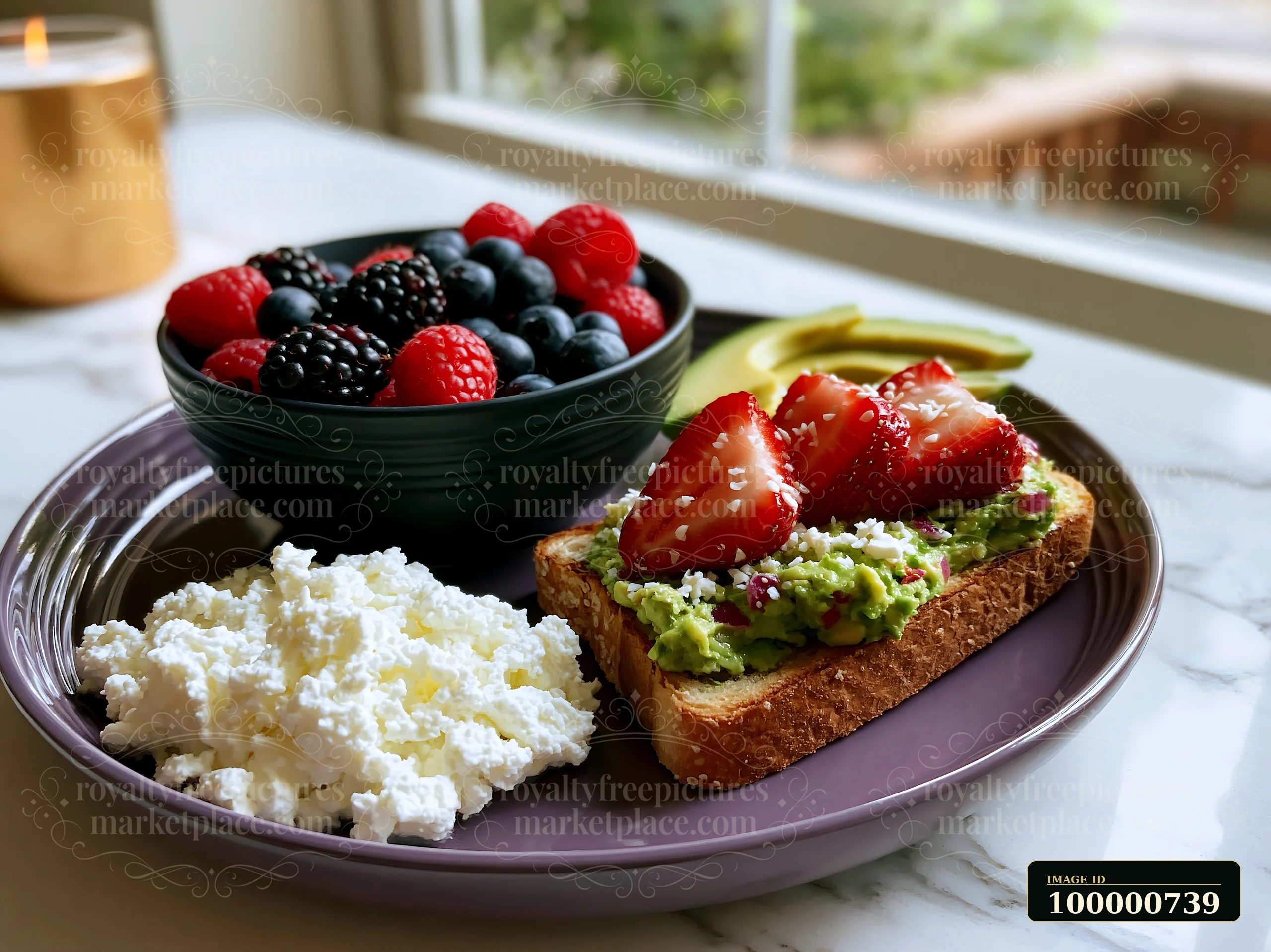 A vibrant plate displays avocado toast topped with strawberries, fresh berries in a bowl, and cottage cheese.