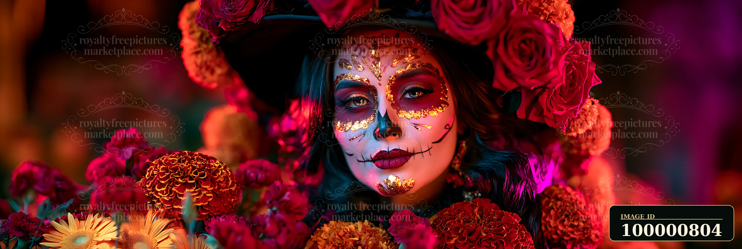 A woman poses for the camera wearing a floral headdress with roses and marigolds while showcasing intricate Day of the Dead makeup.