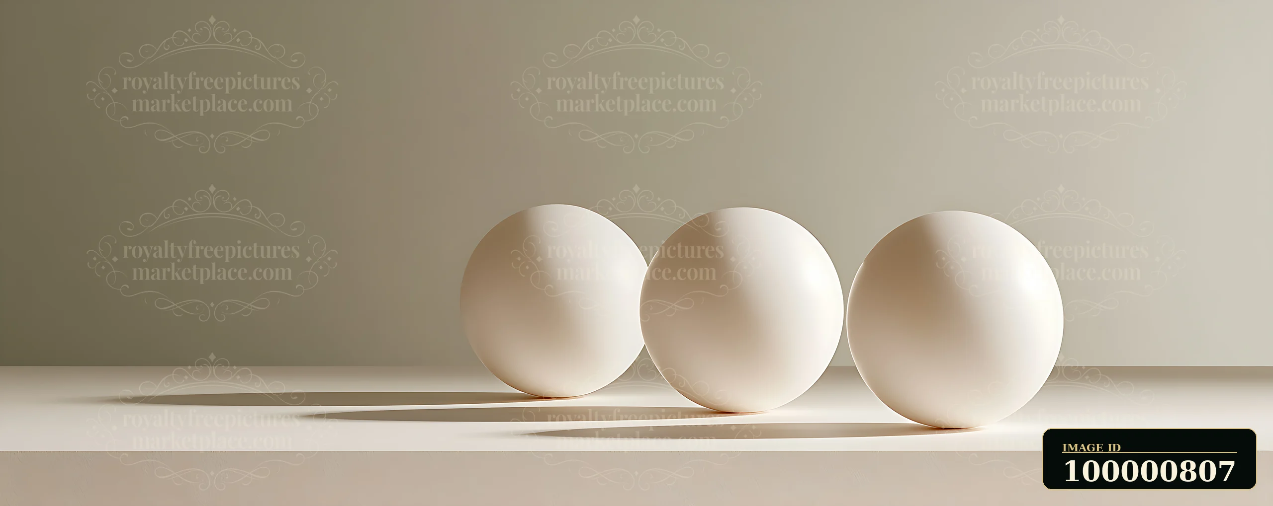 Three round white objects rest on a flat surface.