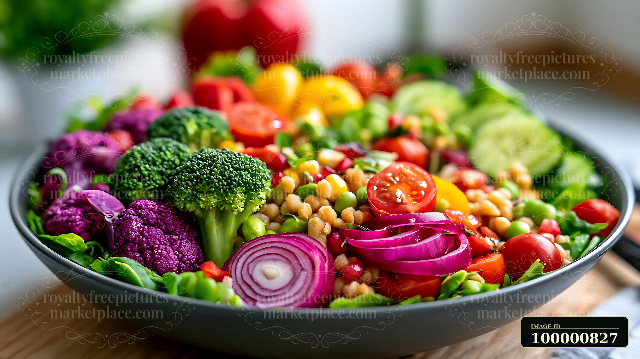 A large bowl filled with colorful vegetables showcases broccoli, tomatoes, red onion, and various greens.