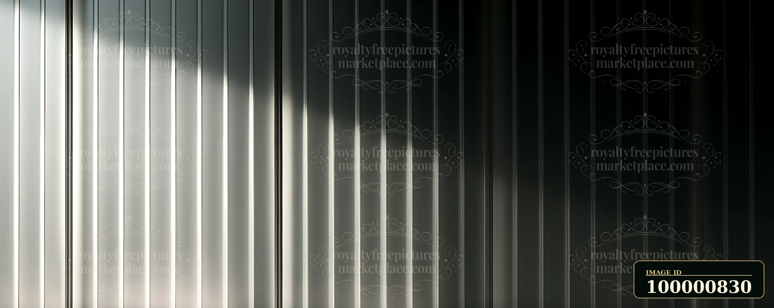 Vertical metal panels reflect light and shadow in a structured pattern.