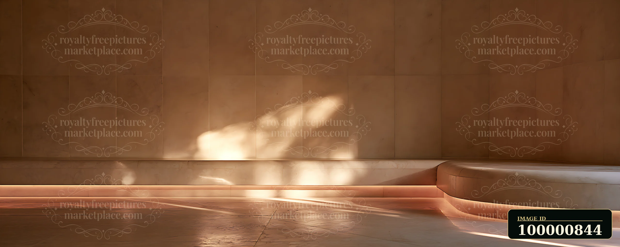 A spacious interior features a simple design with smooth walls and a curved seating area.