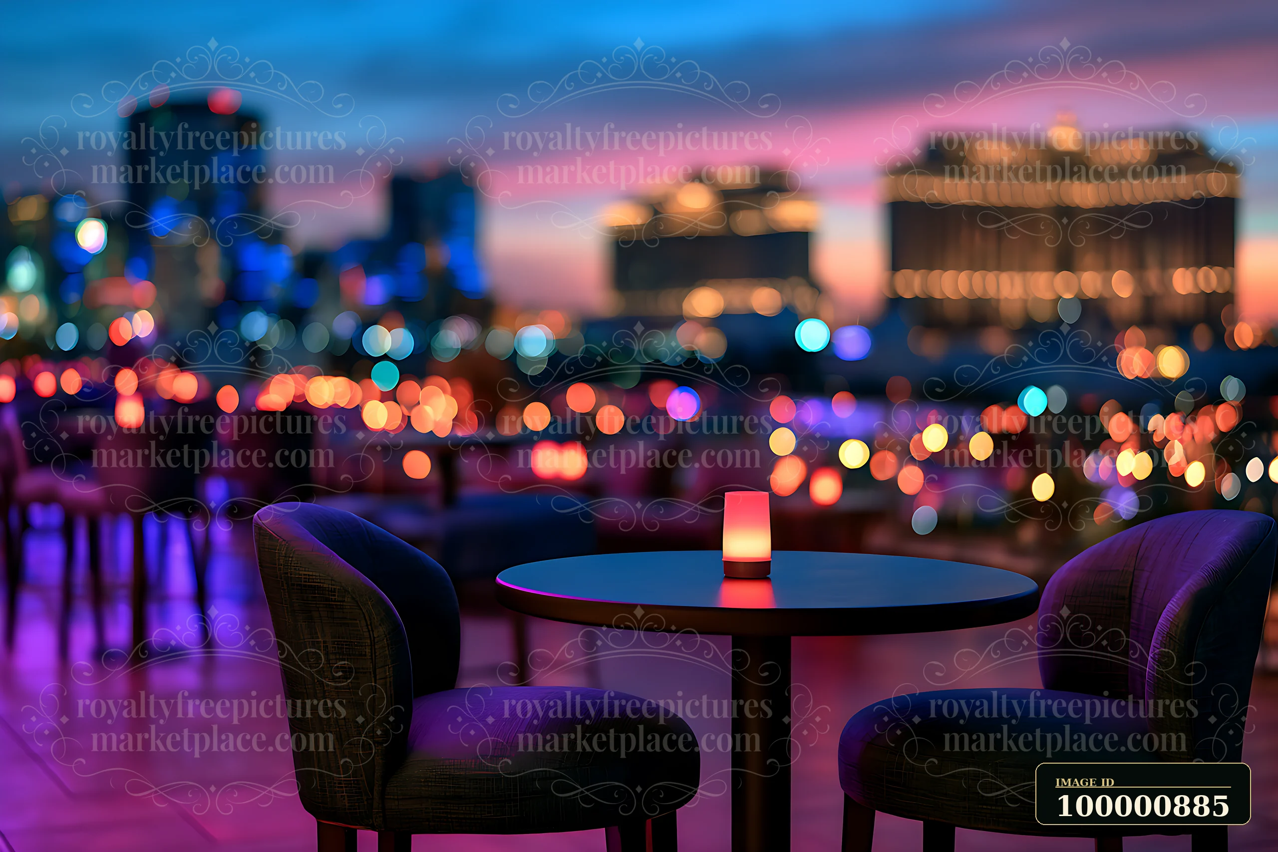 Candlelight sits on a round table in an outdoor seating area overlooking a city skyline during dusk, with colorful lights twinkling in the background.