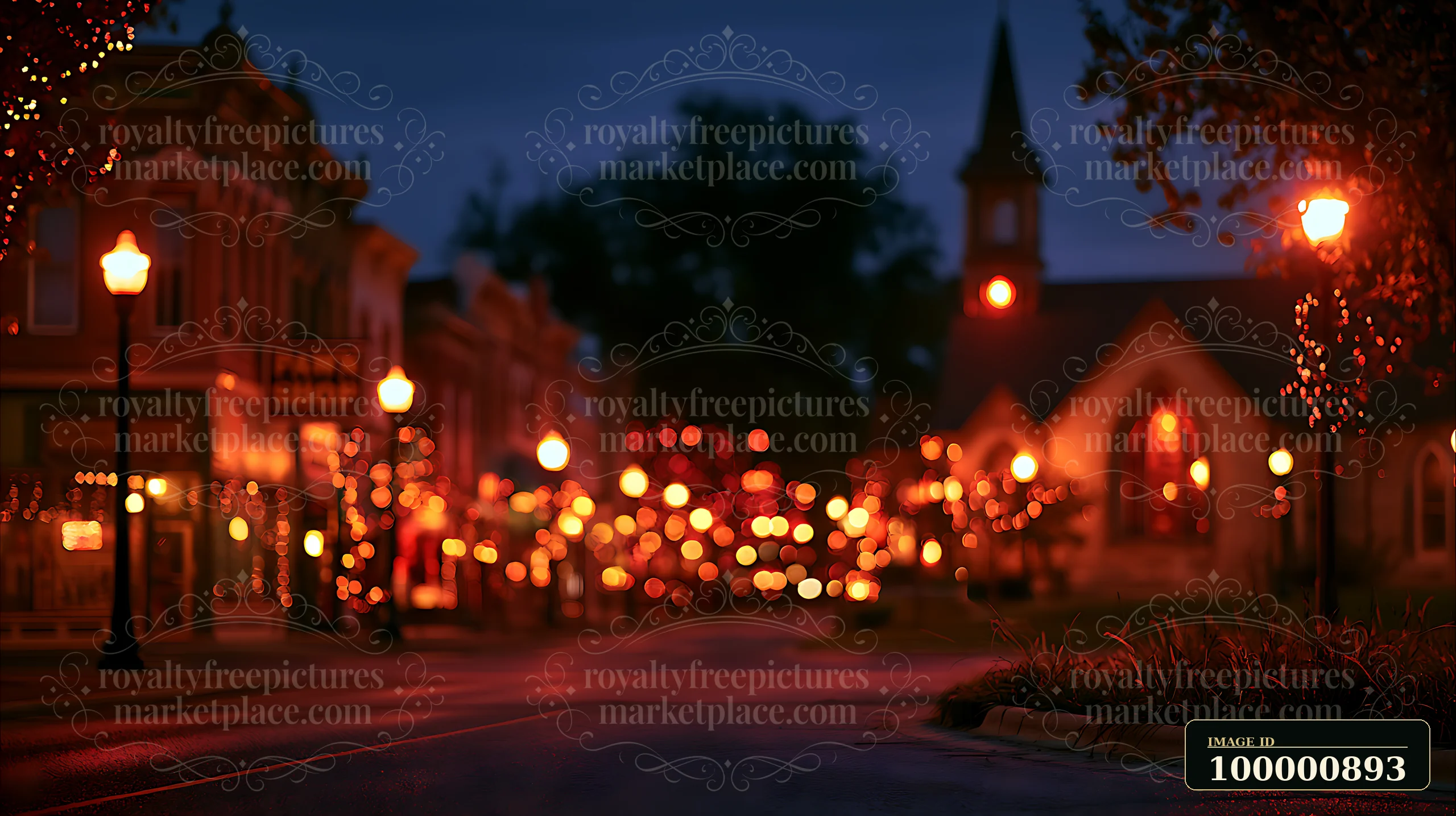 A quiet downtown street features warm lights from shops and trees in the evening.