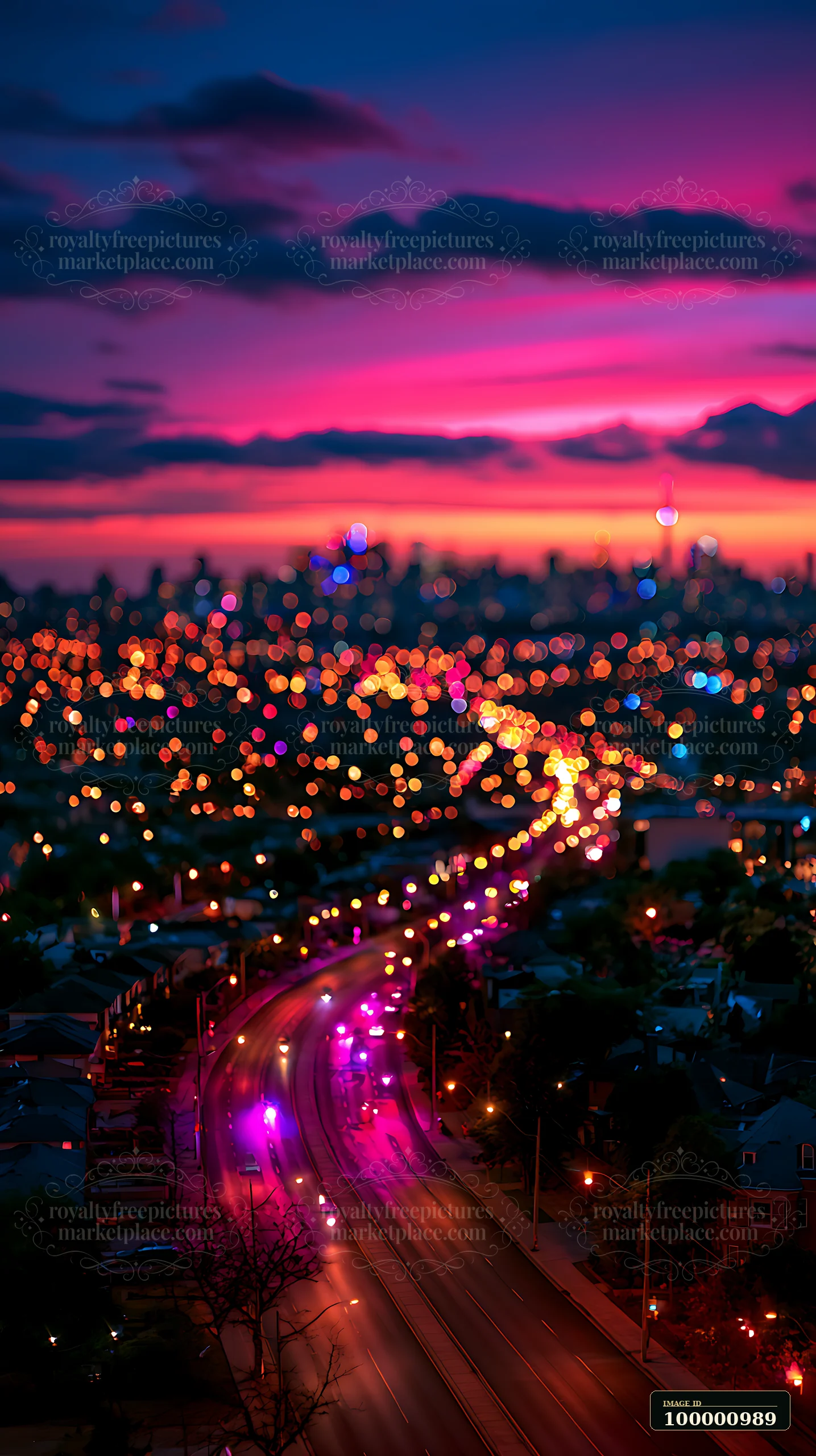 A winding road leads through the city as colorful lights illuminate the dark setting.
