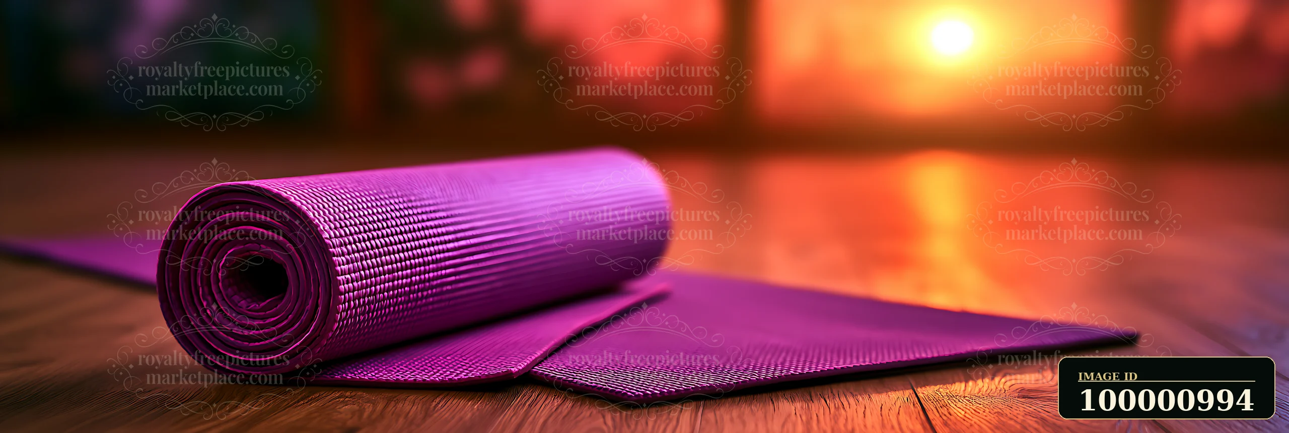 A purple yoga mat sits on a wooden floor, ready for practice as the sun sets outside.