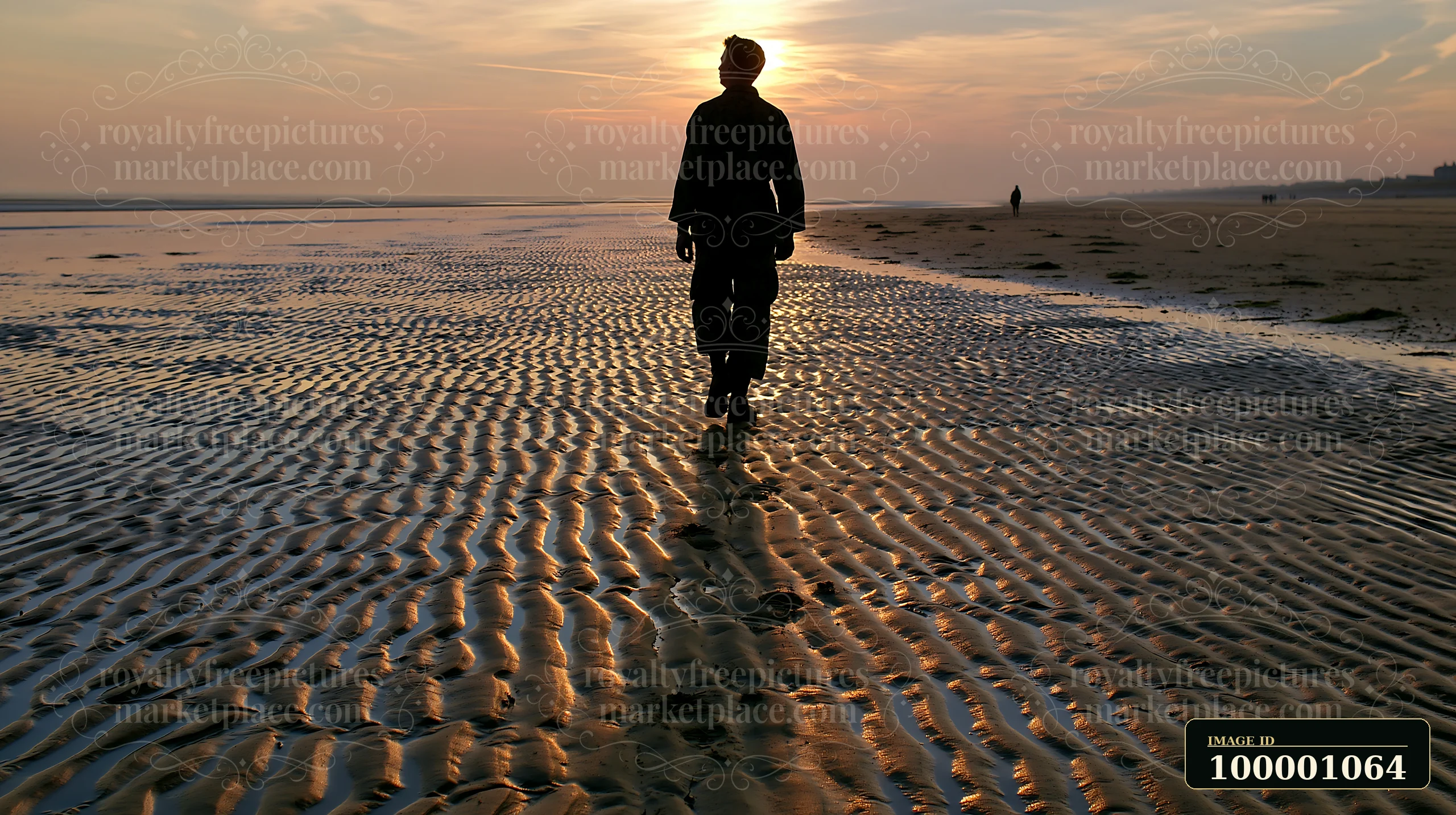 A soldier walks along a sandy beach at sunset, leaving a soldier shadow on ground.