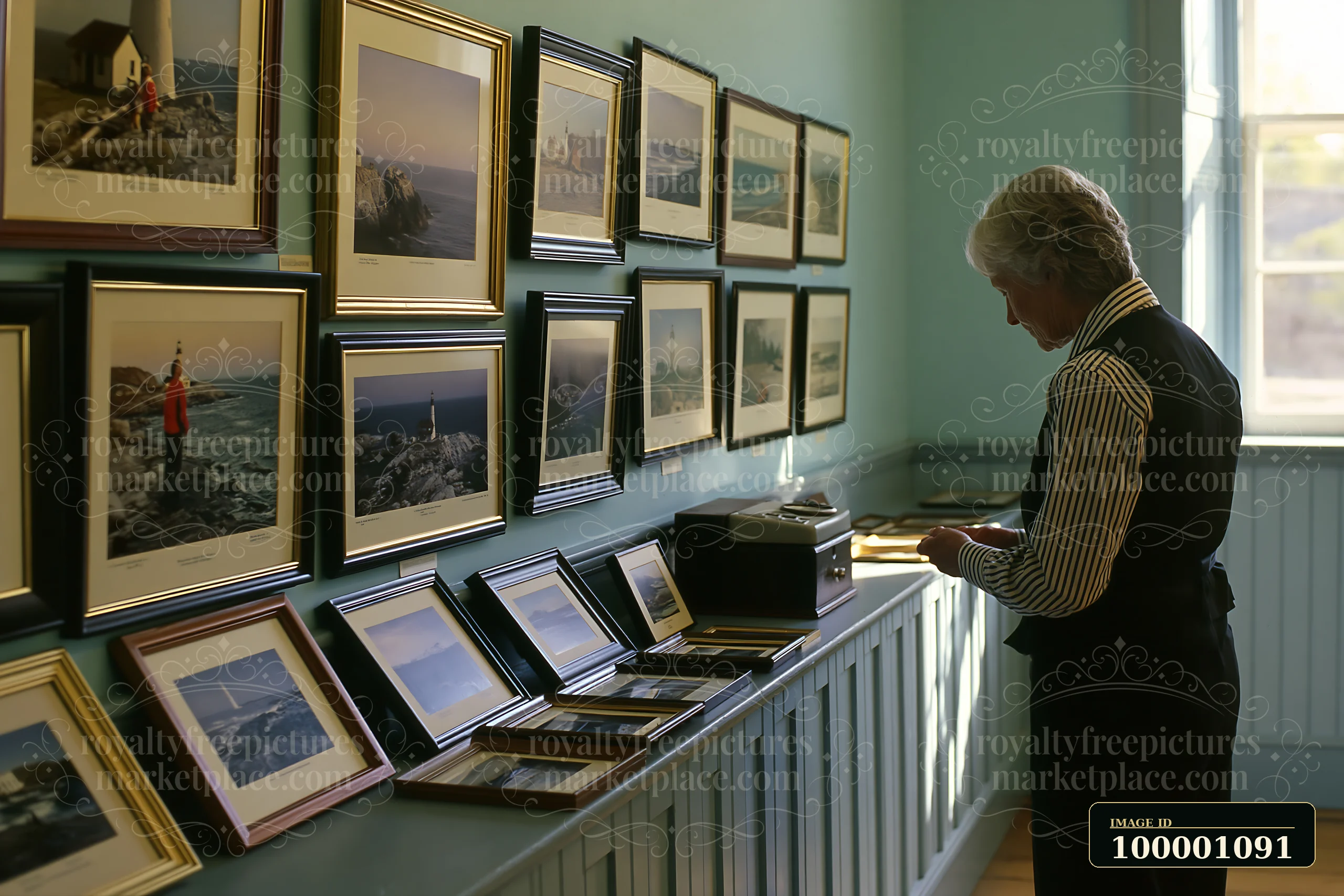 A visitor examines framed photographs in a lighthouse museum interior.