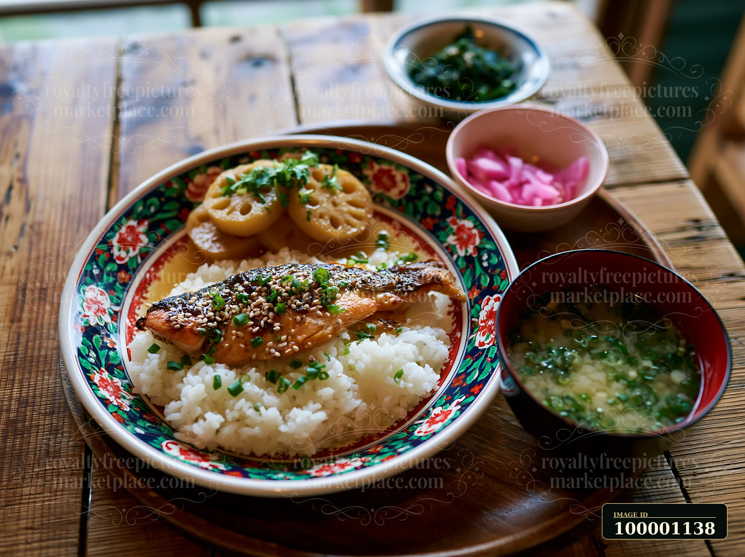 A breakfast plate with Japanese breakfast features grilled fish, rice, vegetables, and side dishes.