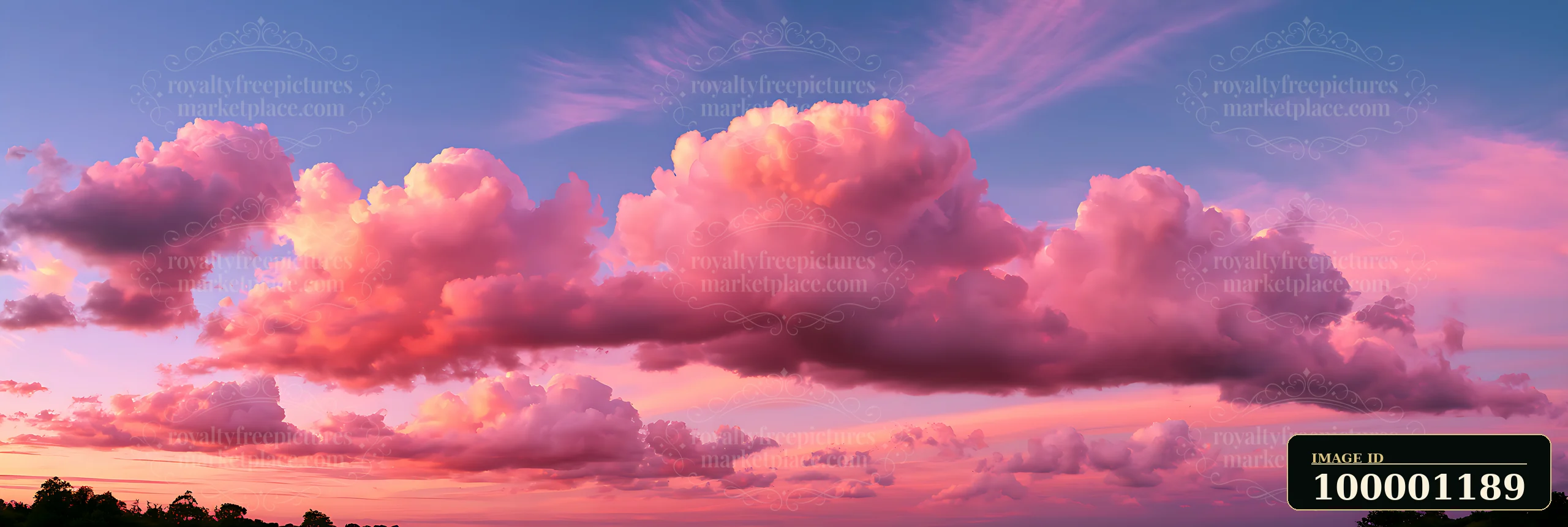 Soft pink clouds float in a vibrant sky during sunset, creating a stunning view.