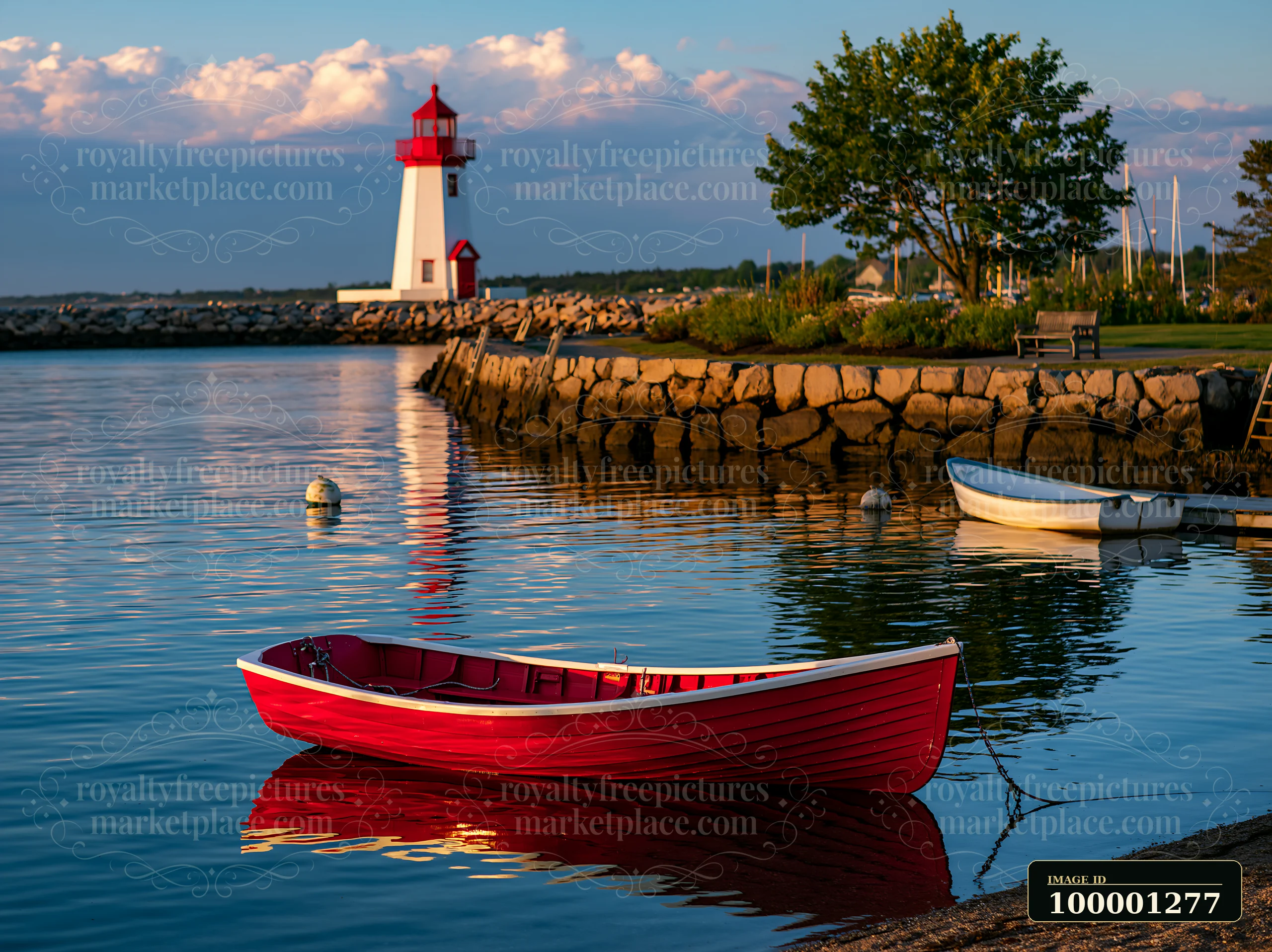 A lighthouse with boats in the foreground stands by the peaceful waters.