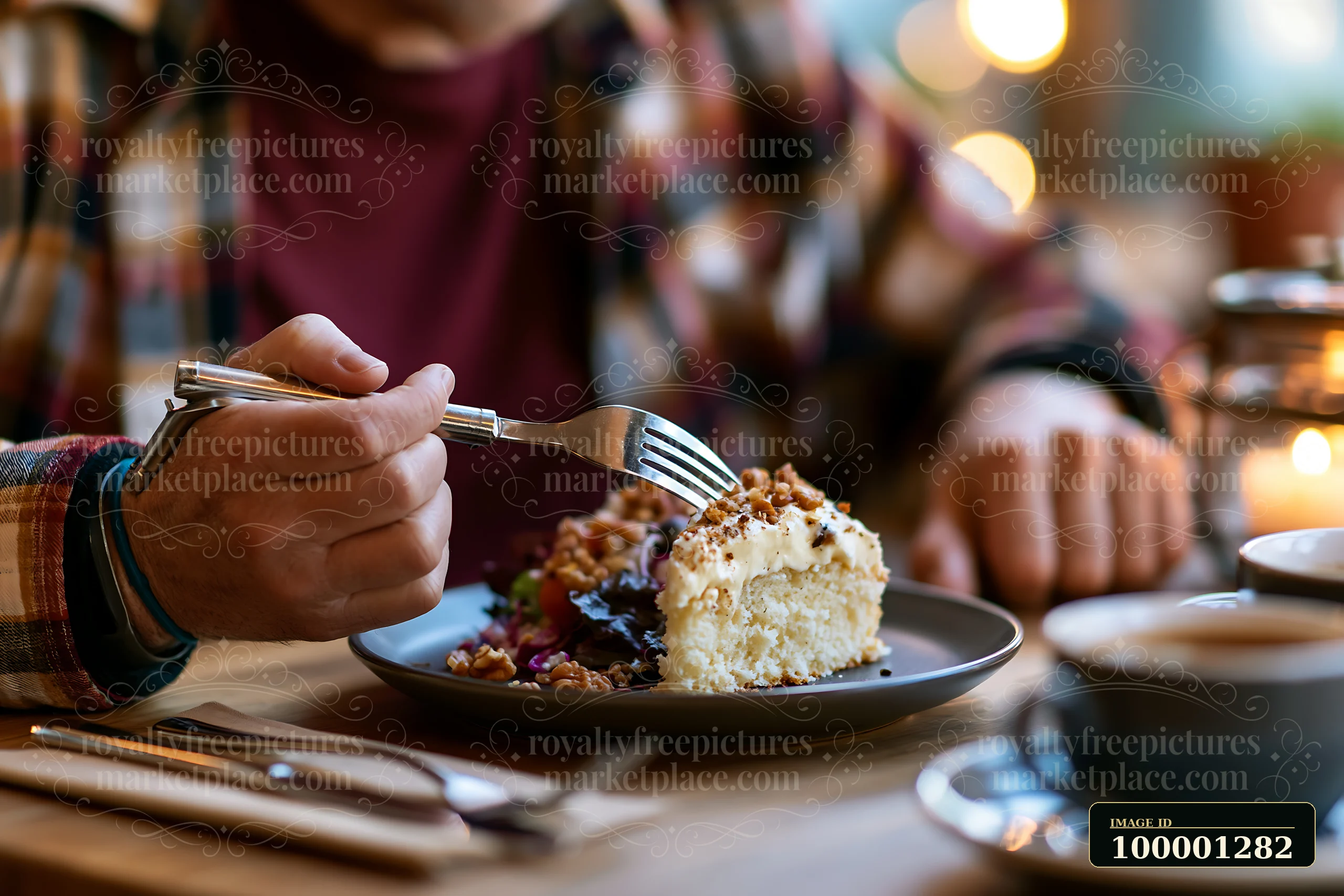A person with limited hand mobility using utensils eats dessert in a cozy cafe.