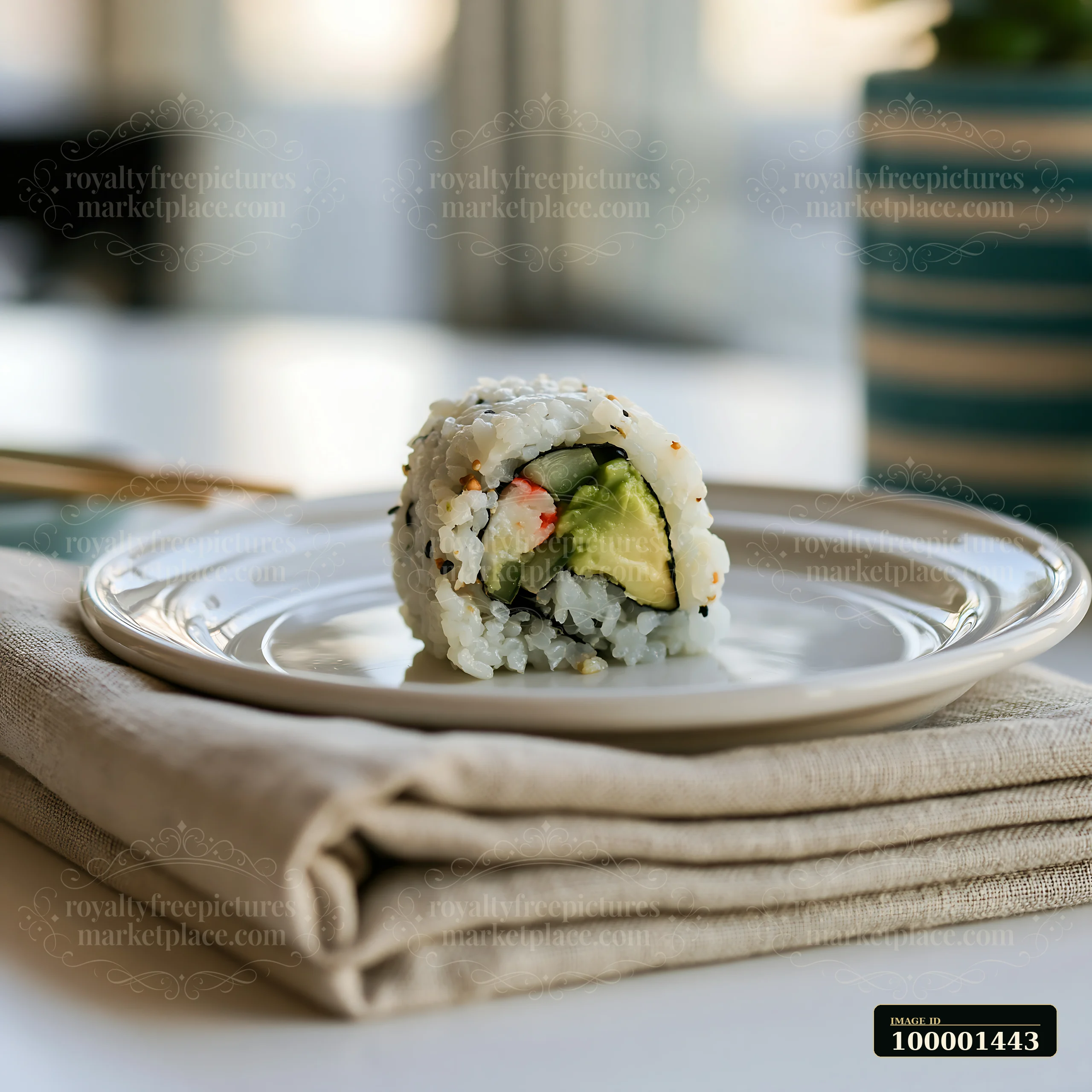 One California roll piece on plate sits ready to eat next to a pair of chopsticks.