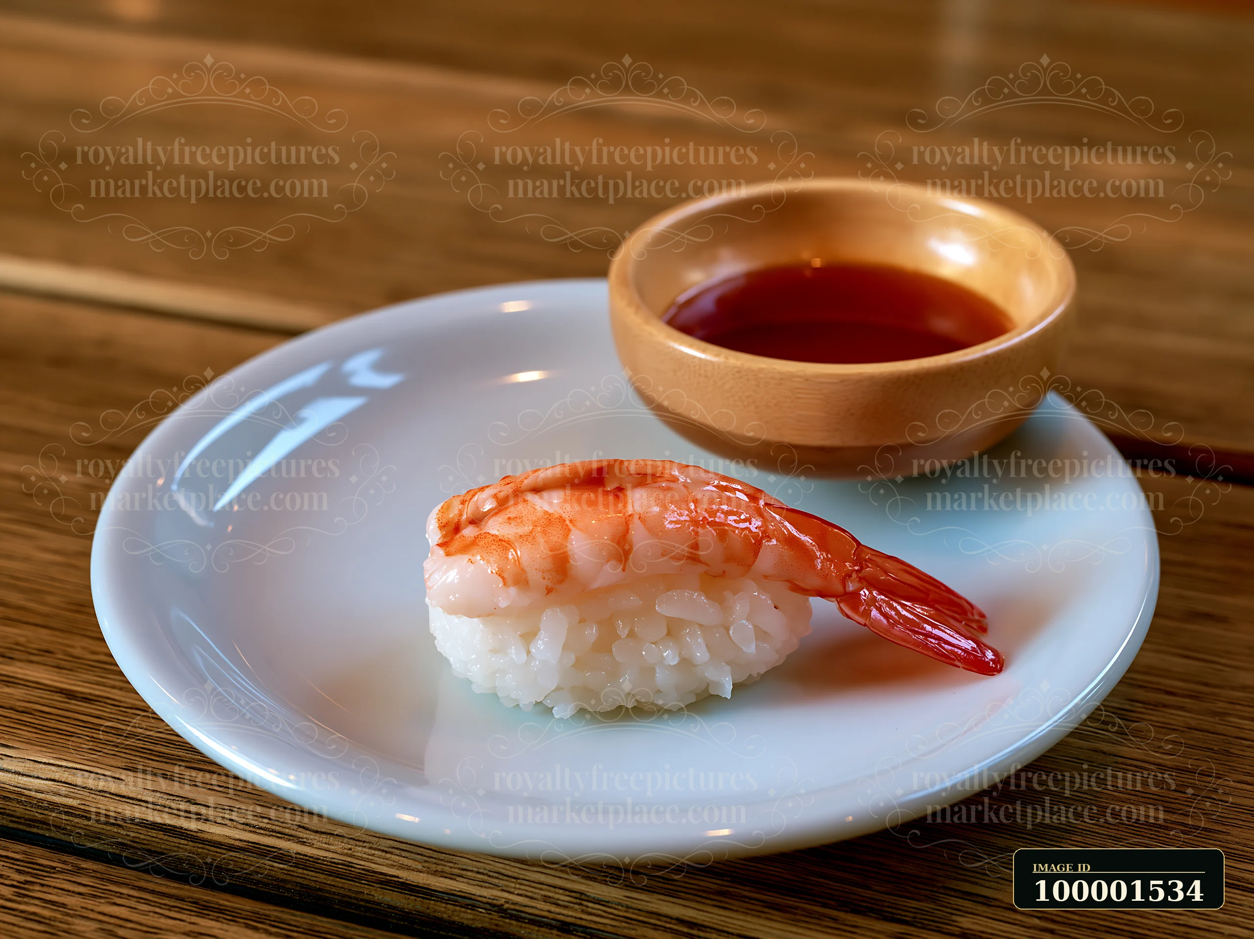One shrimp sushi piece on white plate with a small bowl of dipping sauce.