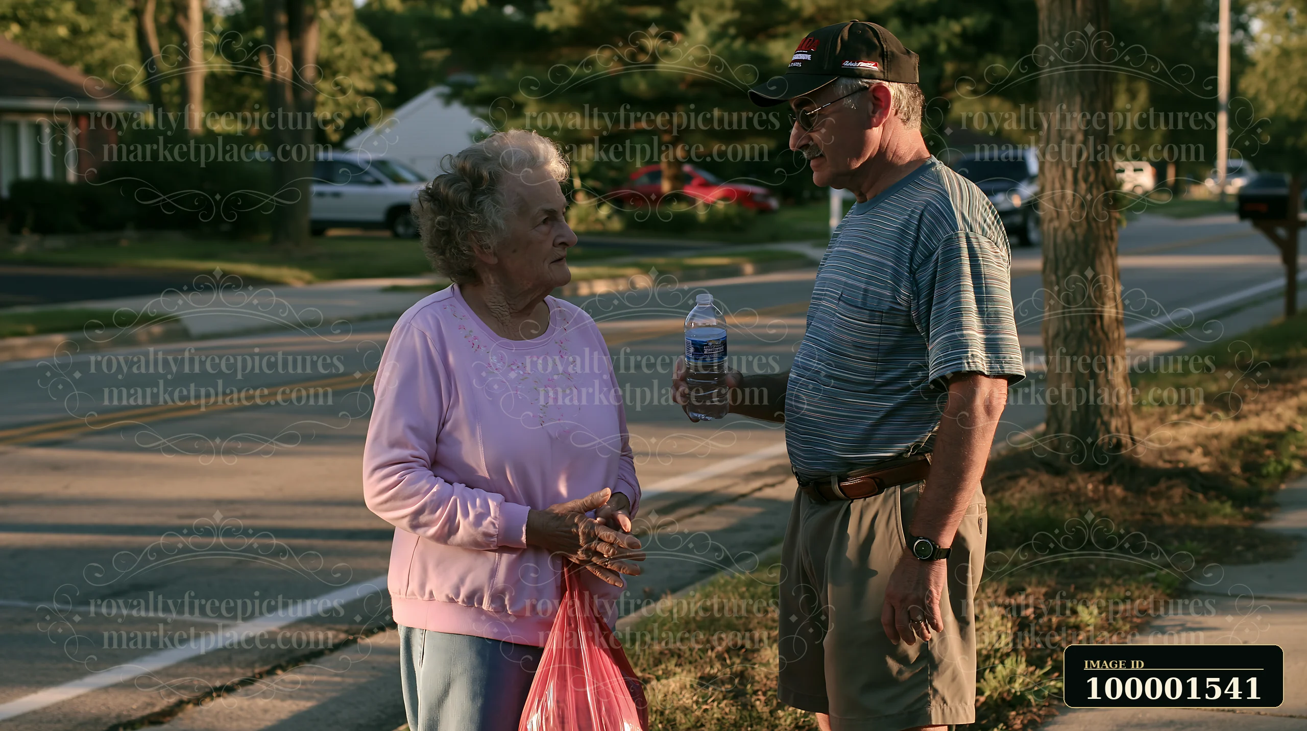 A man converses with a woman outside in a neighborhood as she holds a bag.