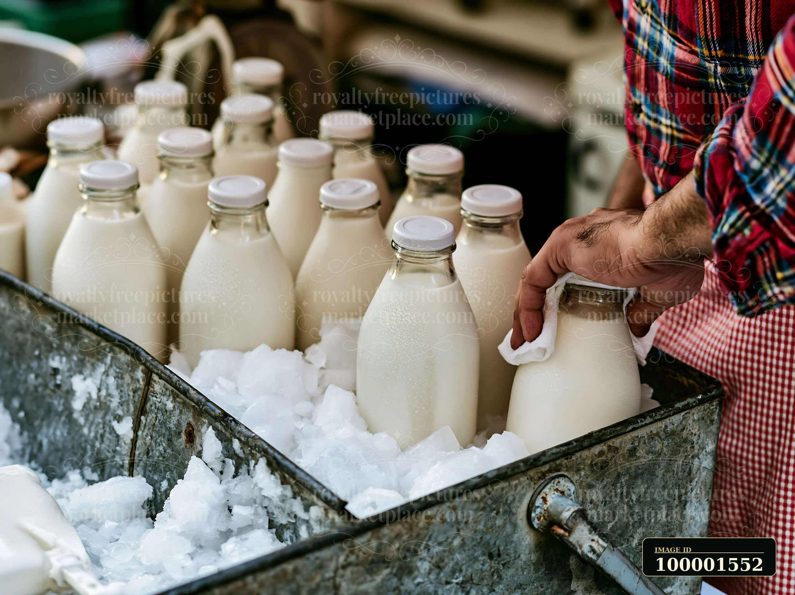 Bottles of artisan milk are displayed on a stall filled with ice, while a vendor prepares to serve a customer in a lively street market.