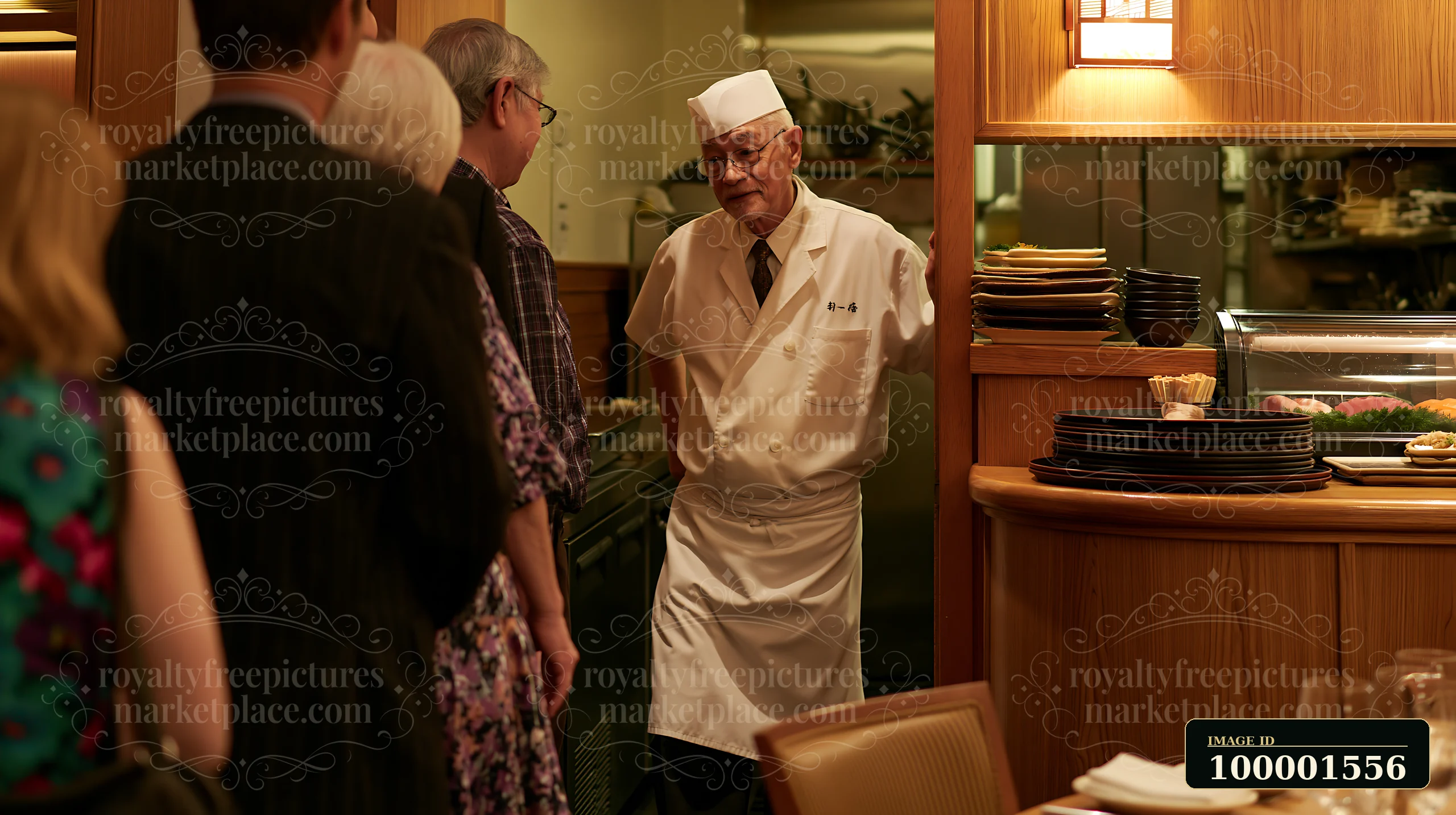 A sushi chef greeting diners in a busy restaurant setting.