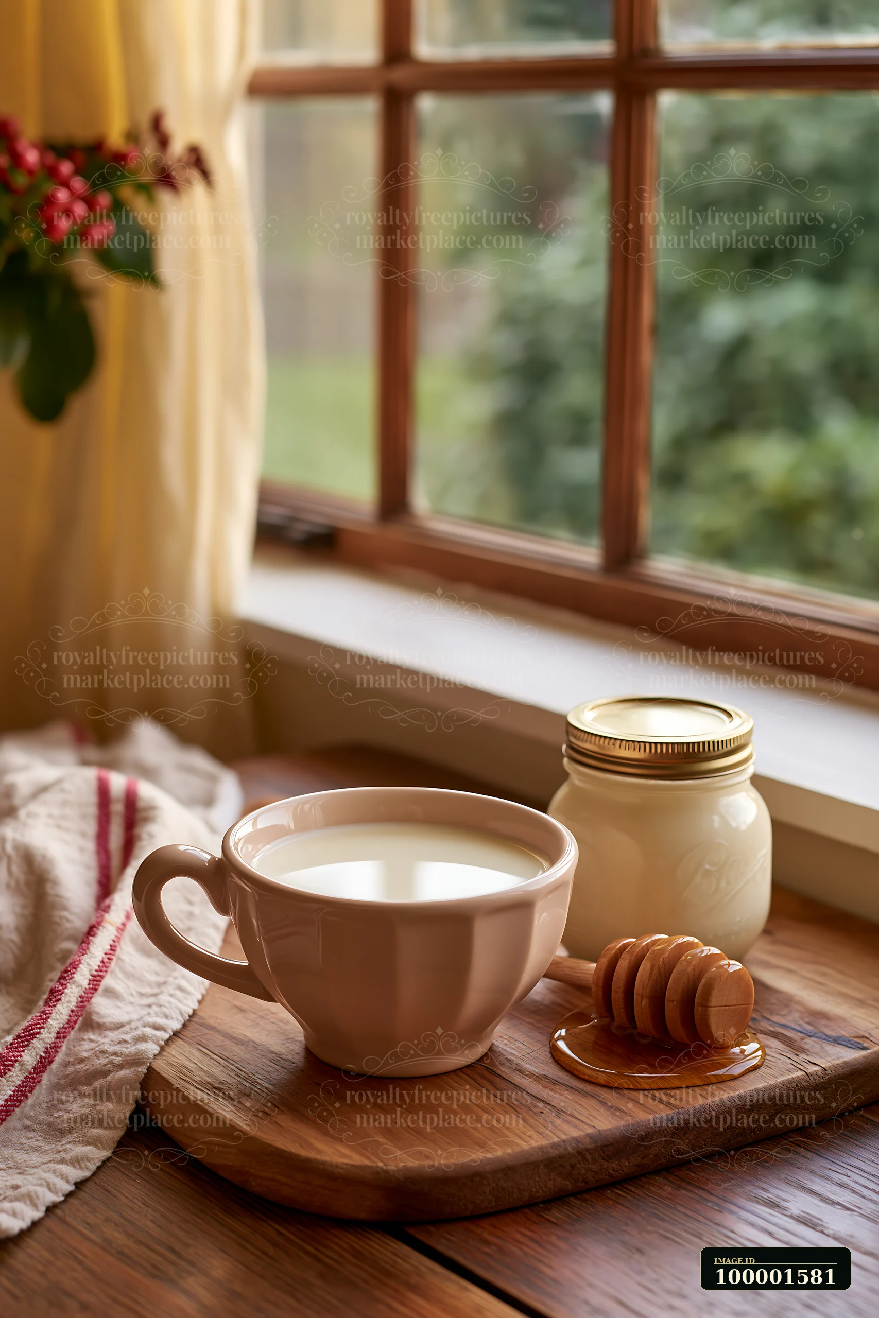 A cup filled with cream sits on a wooden board beside a jar of honey and a honey dipper.