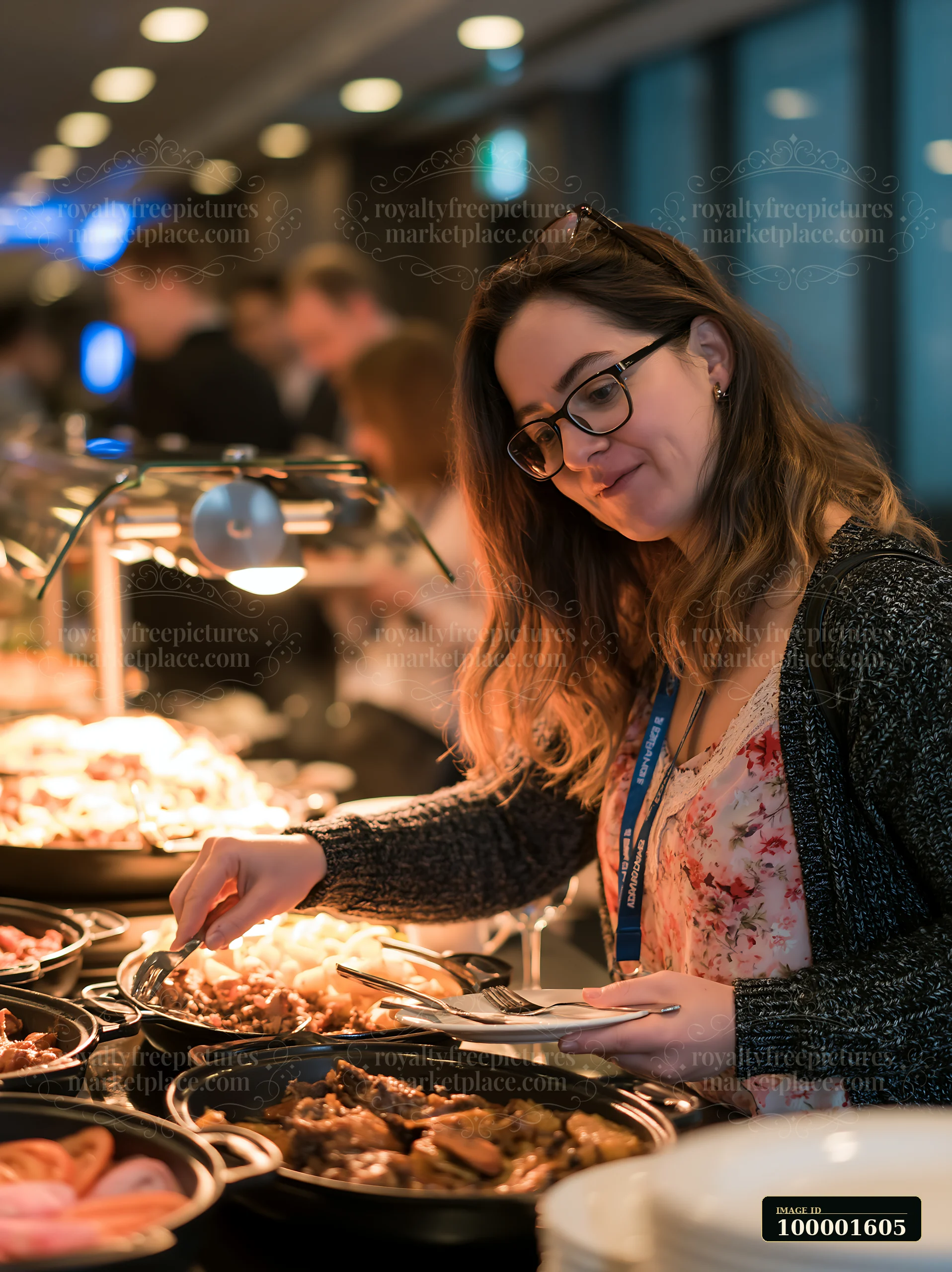 A woman takes food from a buffet at a business conference.