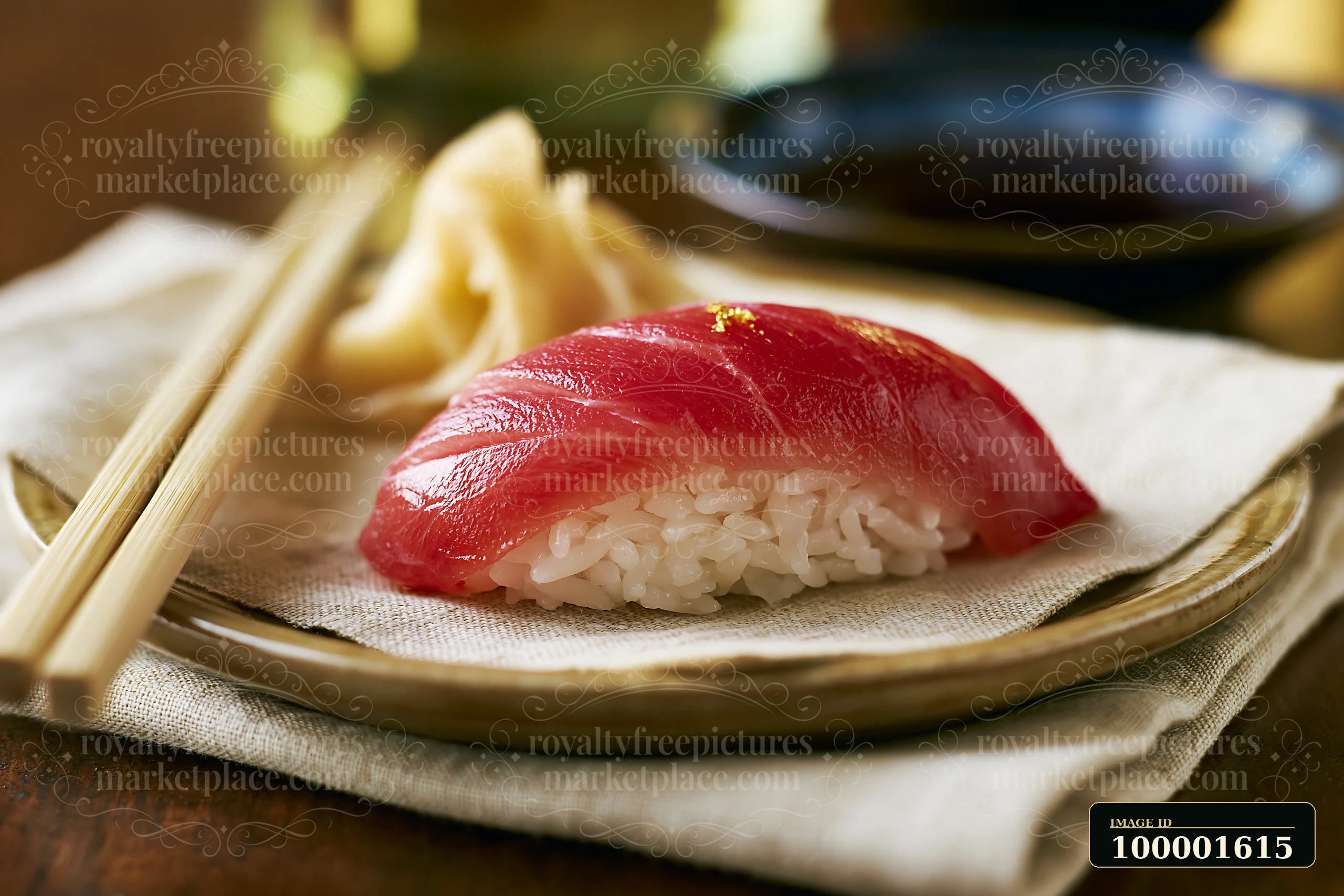One sushi piece with pickled ginger sits on a plate beside chopsticks.