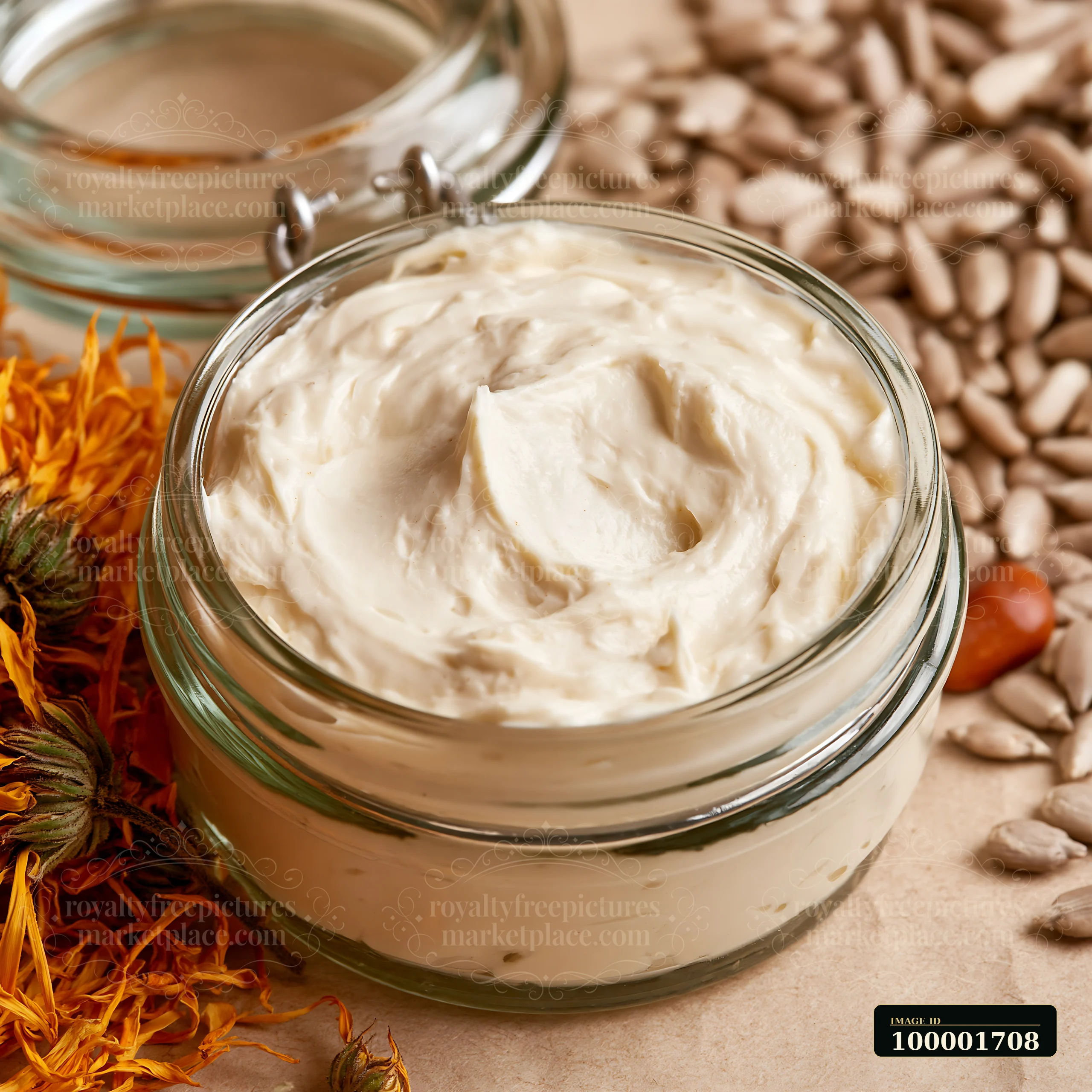 A jar of cream dose with natural skincare ingredients sits on a neutral surface surrounded by sunflower seeds and dried flowers.