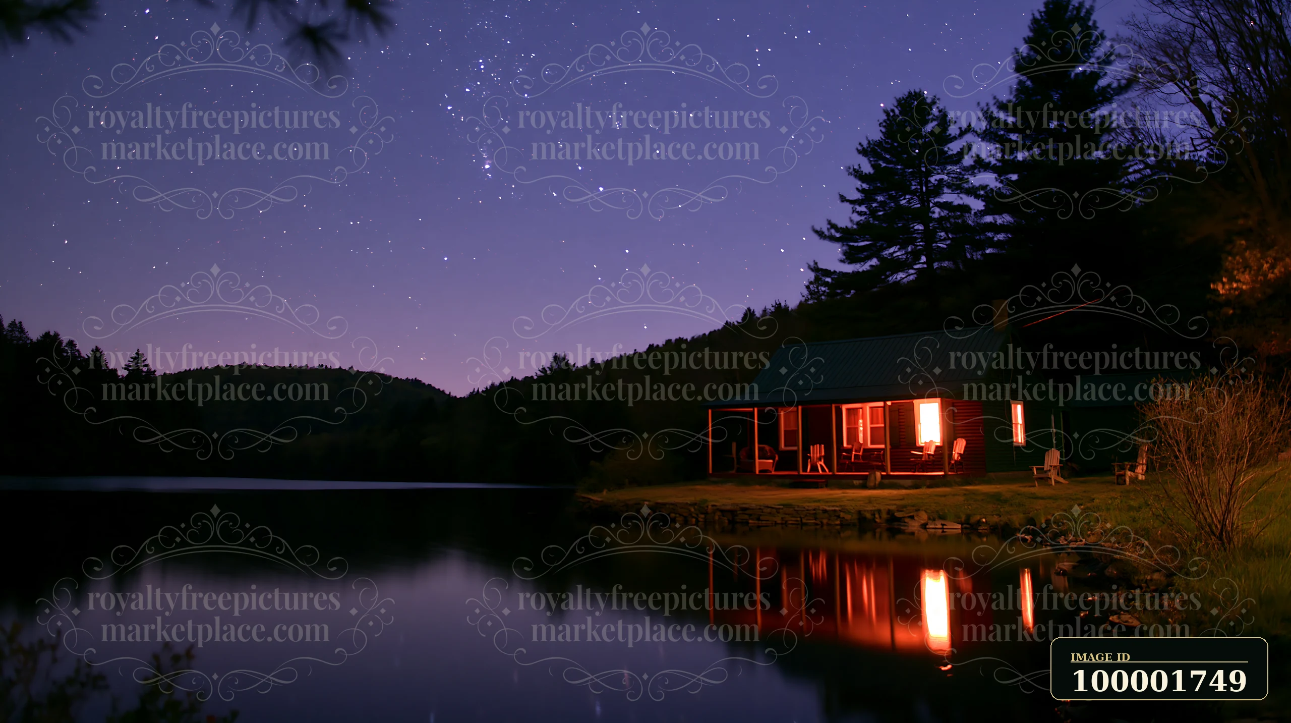 A cottage under stars with an open porch stands next to a lake.